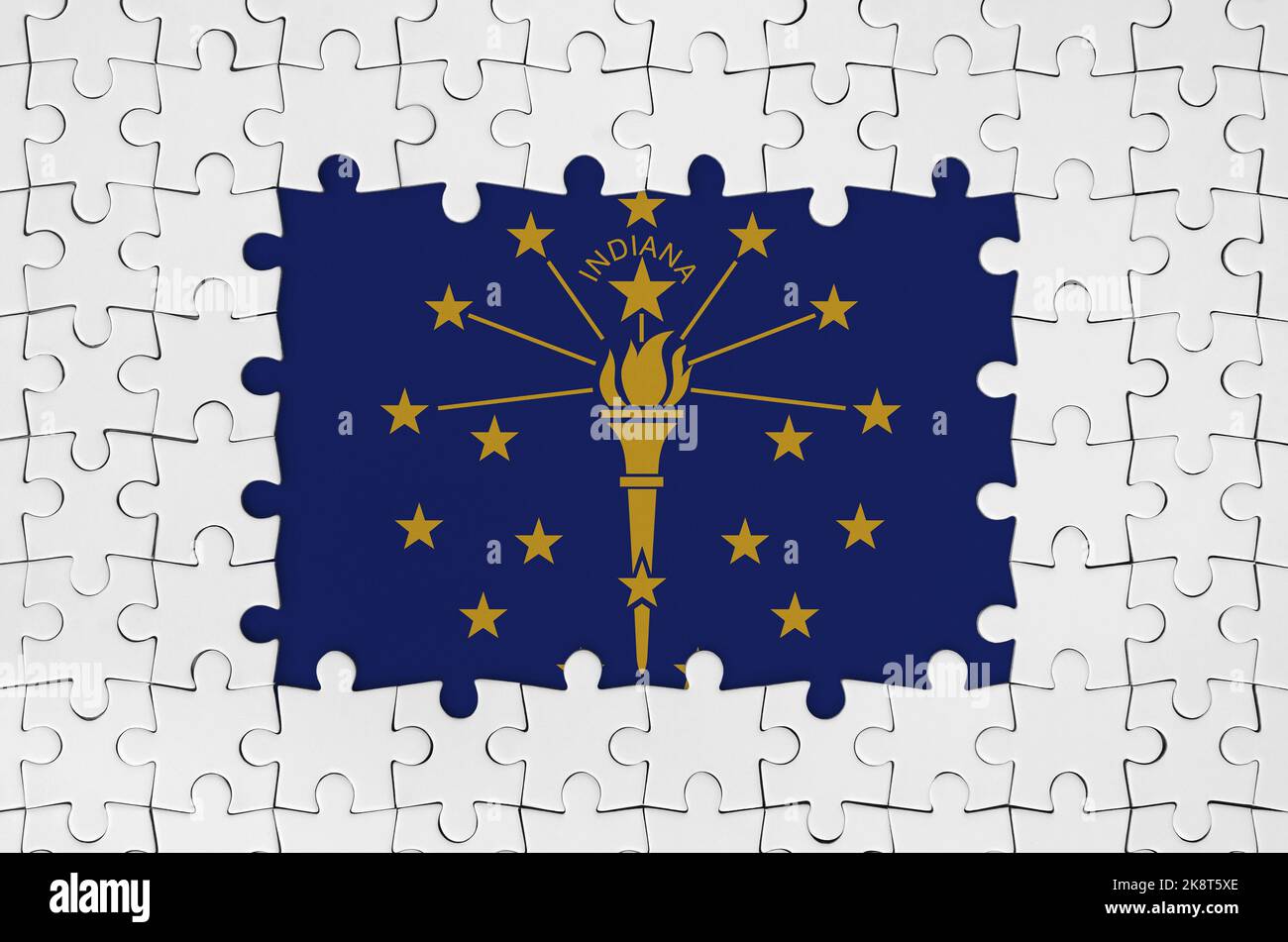 Indiana US state flag in frame of white puzzle pieces with missing central parts Stock Photo