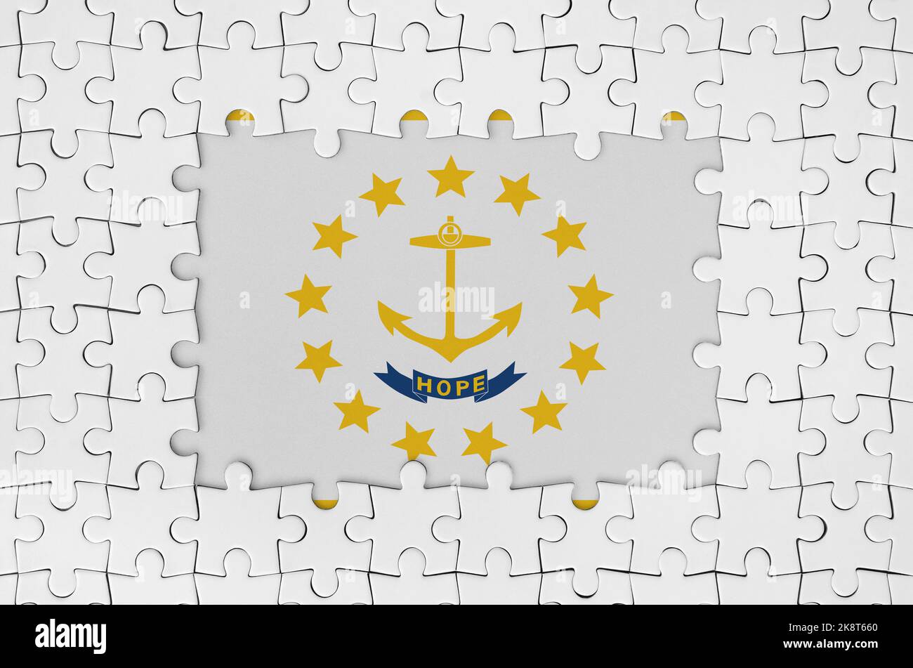 Rhode Island US state flag in frame of white puzzle pieces with missing central parts Stock Photo