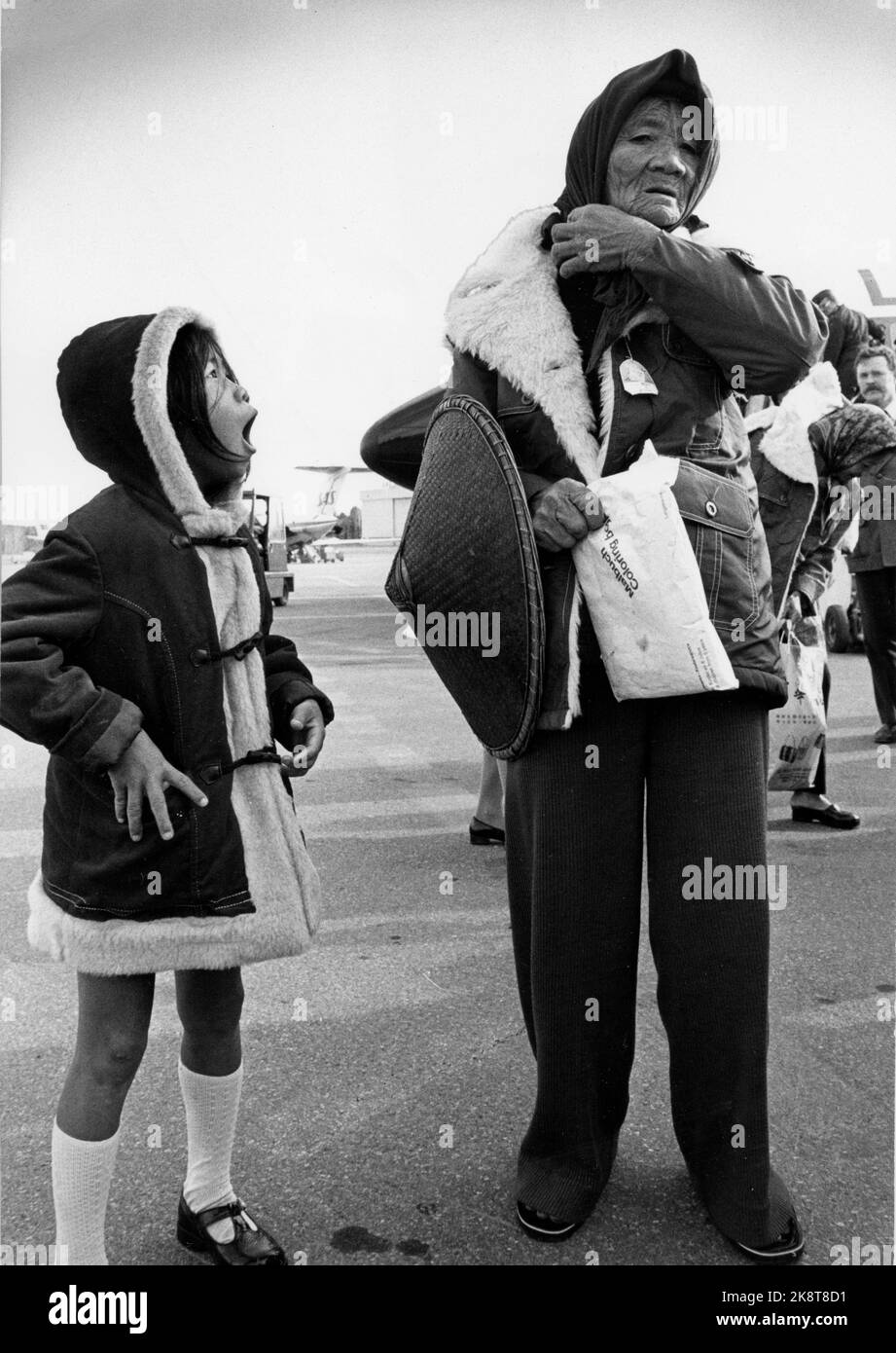 Oslo 19780413. A large group of Vietnamese refugees came to Norway and Fornebu by air after a long journey. Some travel to Bergen, but most stay in Oslo. Here a little girl and an elderly lady dressed in like duffecoats. Cold with knee socks in April in Norway ..... Photo: NTB archive, domestic / NTB Stock Photo
