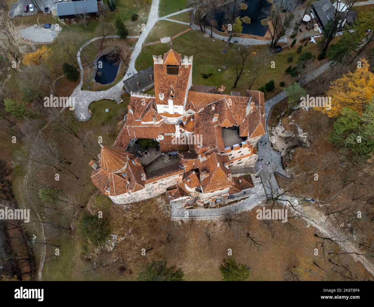 An aerial of a Bran castle with precinct, trees ground around Stock Photo