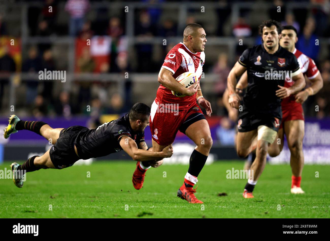 Tonga's Will Penisini (left) and Cook Islands' Kayal Iro in action