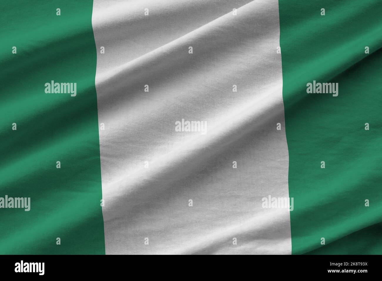 Nigeria flag with big folds waving close up under the studio light