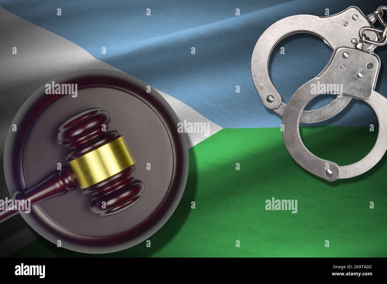 Djibouti flag with judge mallet and handcuffs in dark room. Concept of criminal and punishment, background for guilty topics Stock Photo