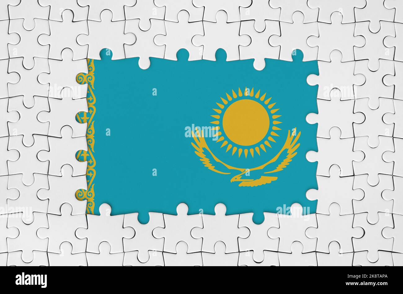 Kazakhstan flag in frame of white puzzle pieces with missing central