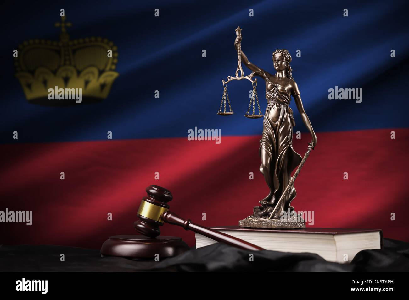 Liechtenstein flag with statue of lady justice, constitution and judge ...