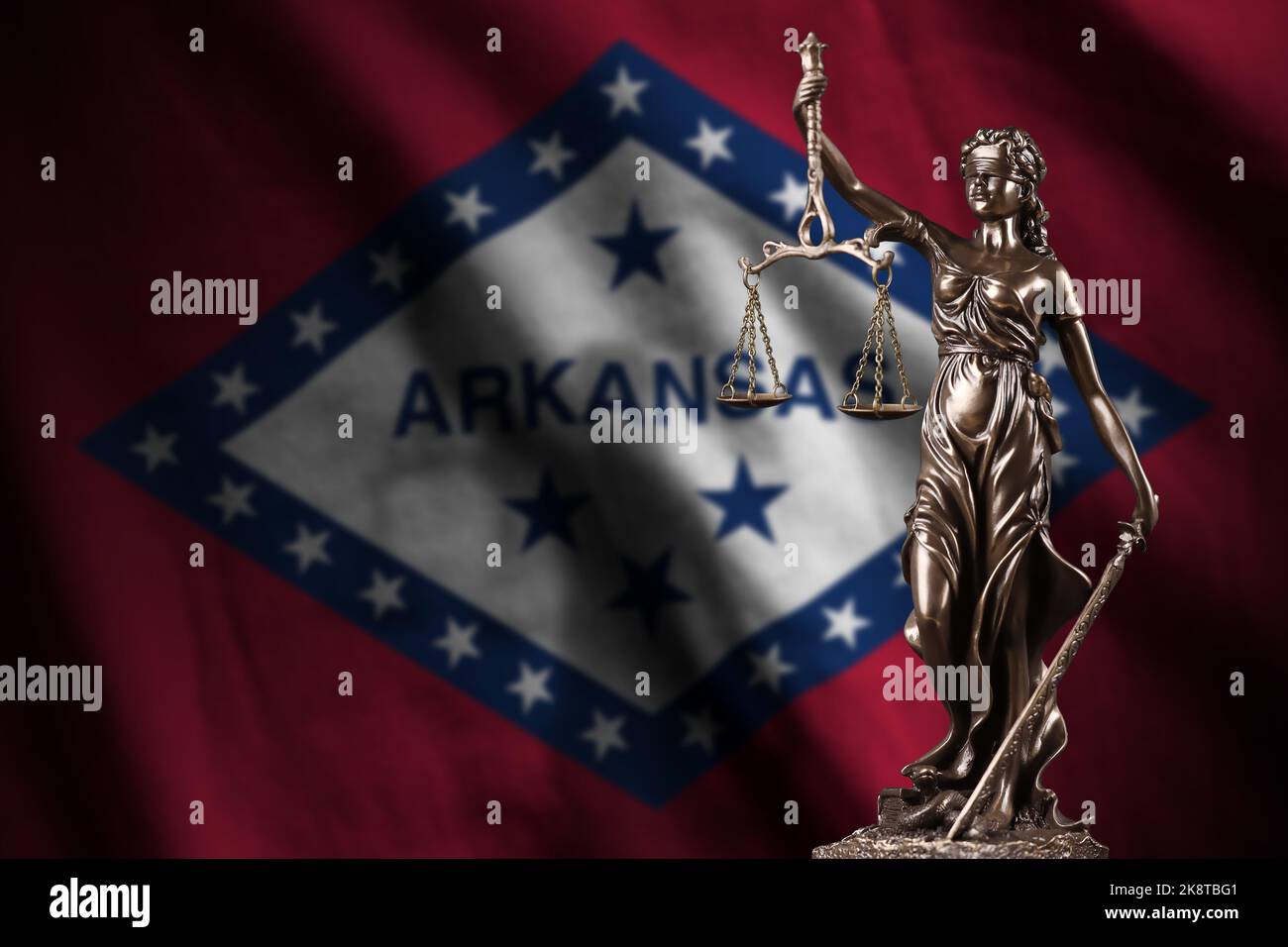 Arkansas US state flag with statue of lady justice and judicial scales