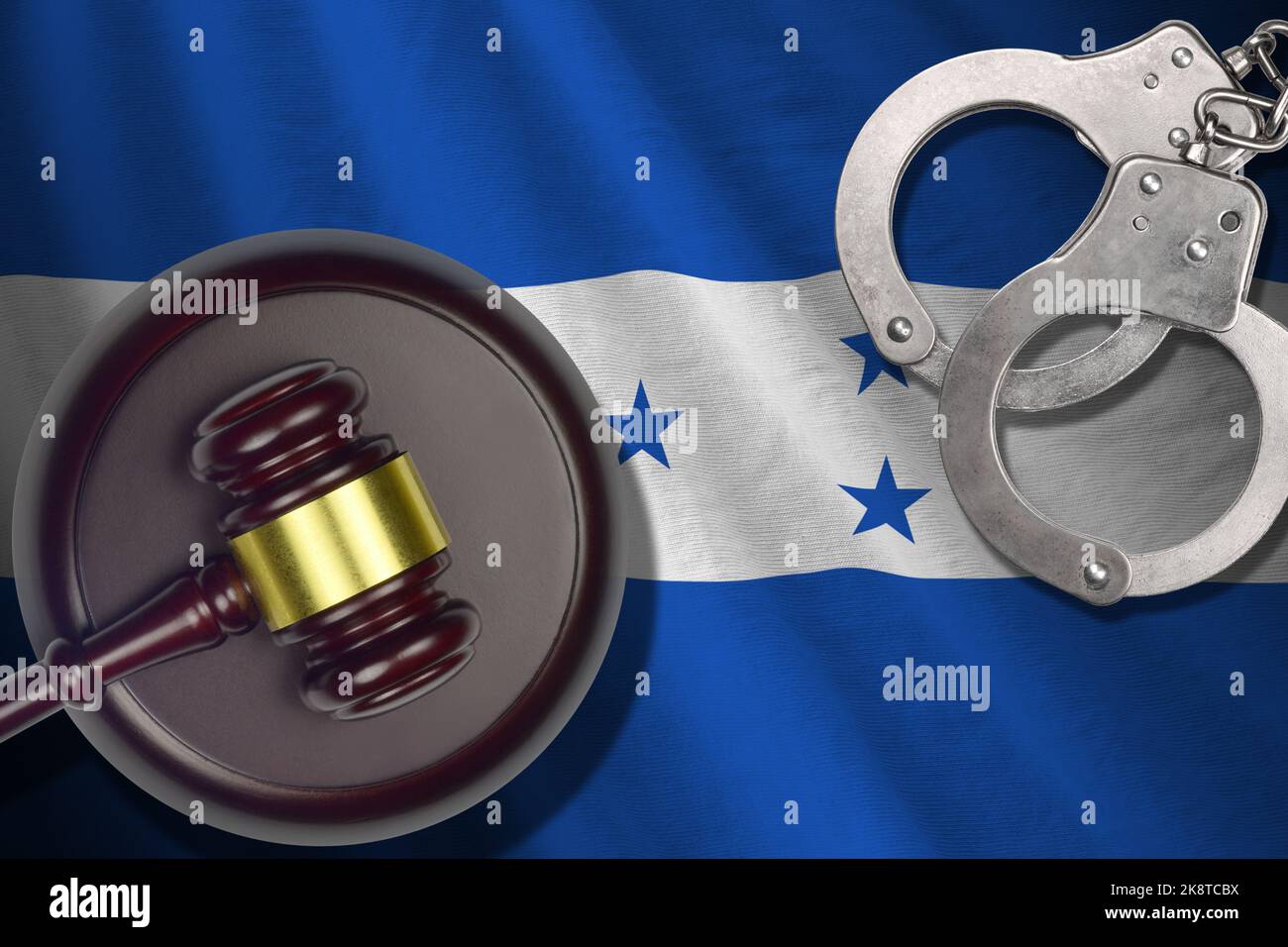 Honduras flag with judge mallet and handcuffs in dark room. Concept of criminal and punishment, background for guilty topics Stock Photo