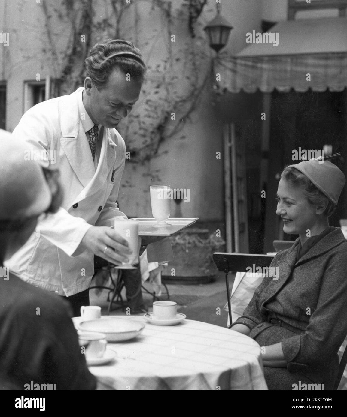 Oslo 1957. Two glasses of milk please! Serving milk at outdoor restaurant. Waiter. Photo Sverre