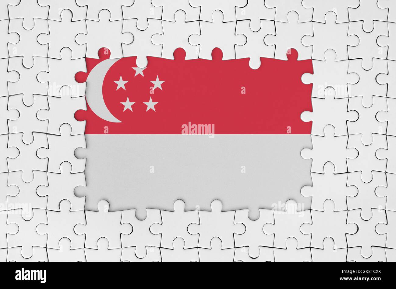 Singapore flag in frame of white puzzle pieces with missing central