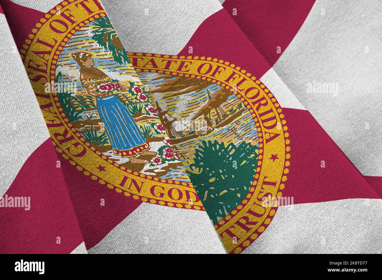 Florida US state flag with big folds waving close up under the studio light indoors. The official symbols and colors in fabric banner Stock Photo
