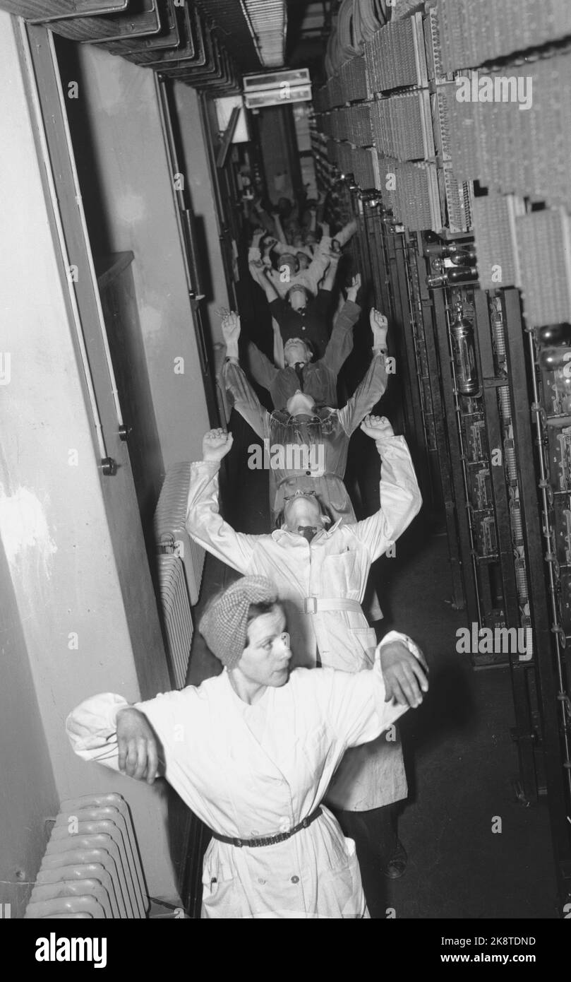 Oslo 19470726. Gymnastics during working hours. In Oslo telephone facilities there has been gymnastics during working hours for 1.5 years with very encouraging results. Here from the center telephone exchange, the staff, women and men are about each other who perform relaxation exercises after music and the instruction through the speaker. Photo: Current / NTB Stock Photo