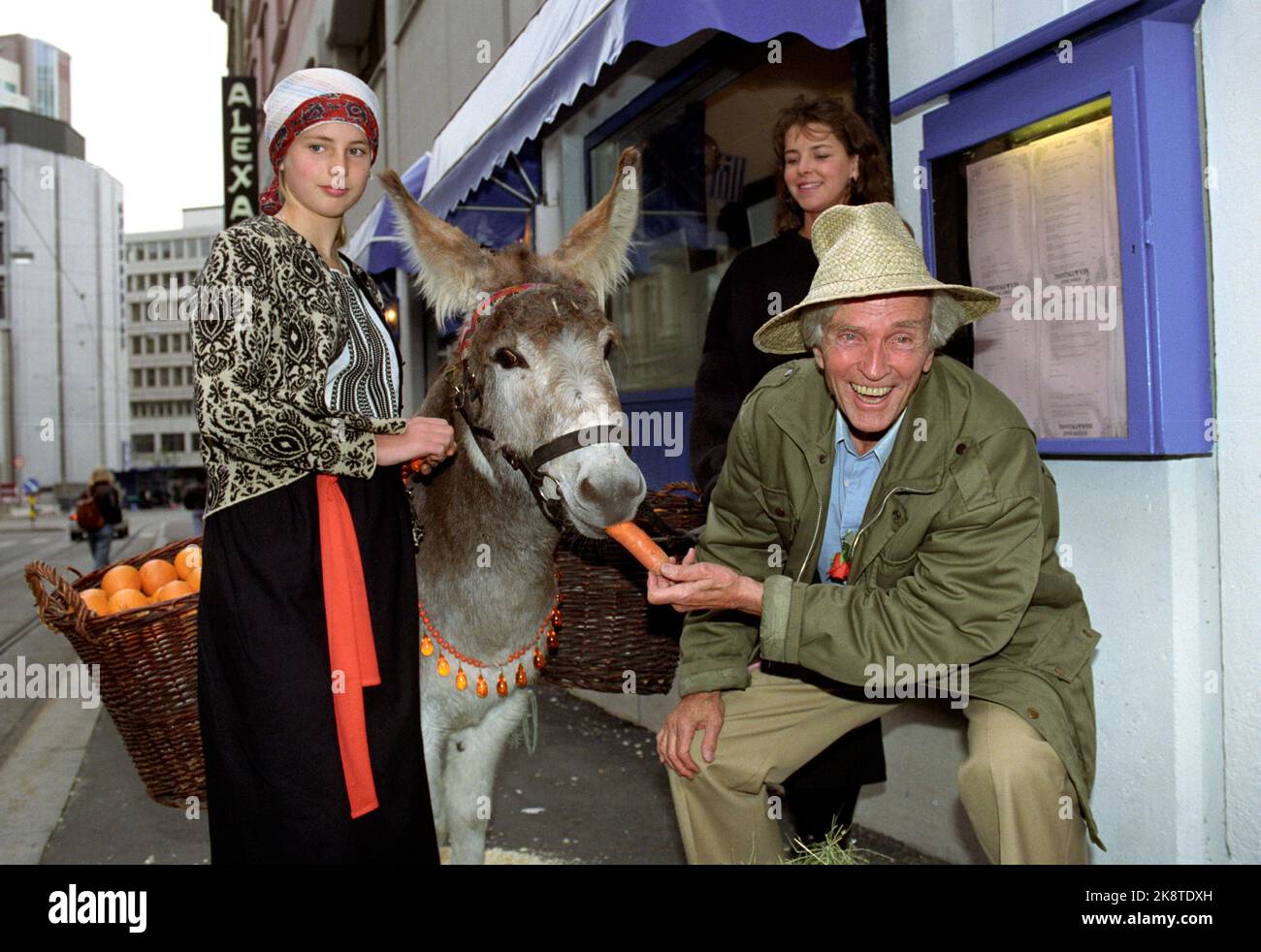 Oslo 19911015 - painter and author Ferdinand Finne presents his new book 'Ringer in a Sea'. Here along with a party -decorated donkey that is fed with carrots. Photo: Ingar Johansen Scanfoto / NTB Stock Photo