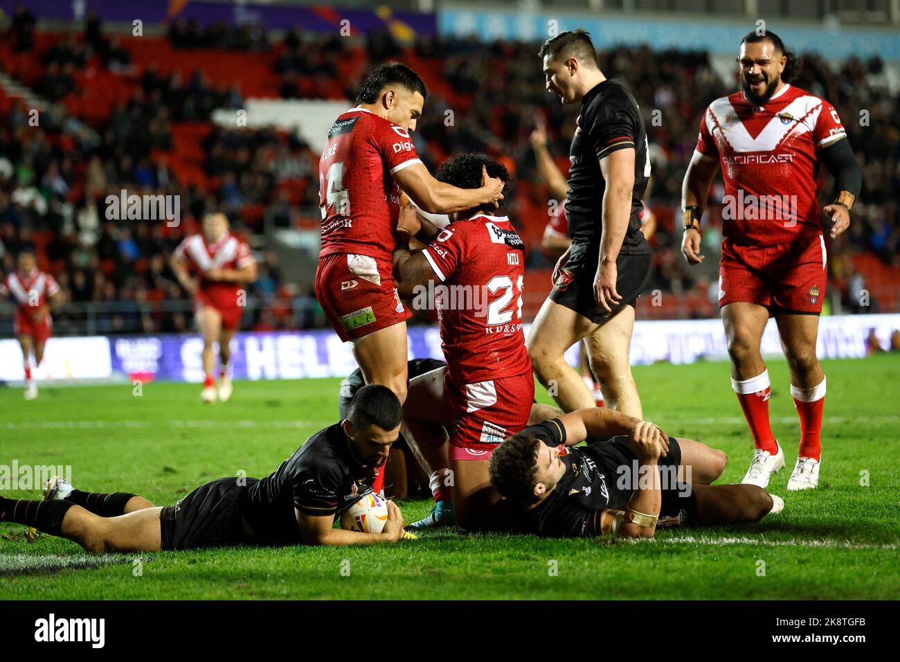 Tonga's Tesi Niu (centre) celebrates scoring his side's fourth try of