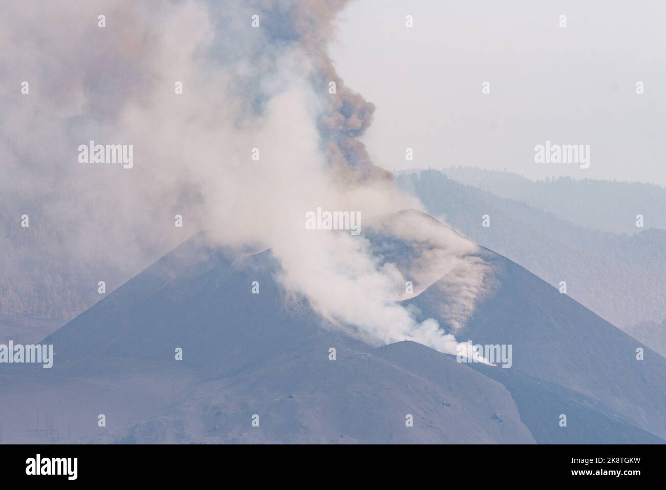 Thick steam coming out of the top of a volcano mountain Stock Photo