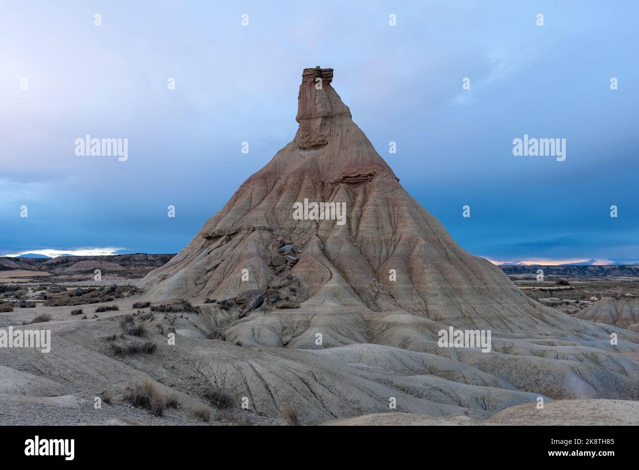 A scenic shot of a sandstone tower created by erosion at the Bardenas Reales in Navarre, Spain ...