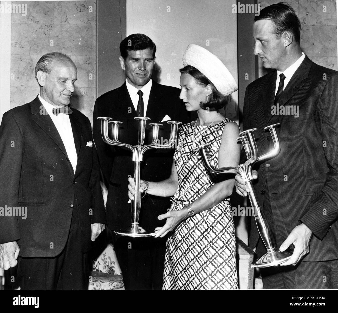 Oslo 1968-08-29: Royal Norwegian wedding. Crown Prince Harald marries Sonja Haraldsen. The couple received a lot of gifts. Here they receive the gift from Asker municipality. Candlesticks in tin / silver? Sonja in hat and short dress, Harald in suit. NTB - Stock Photo. Stock Photo