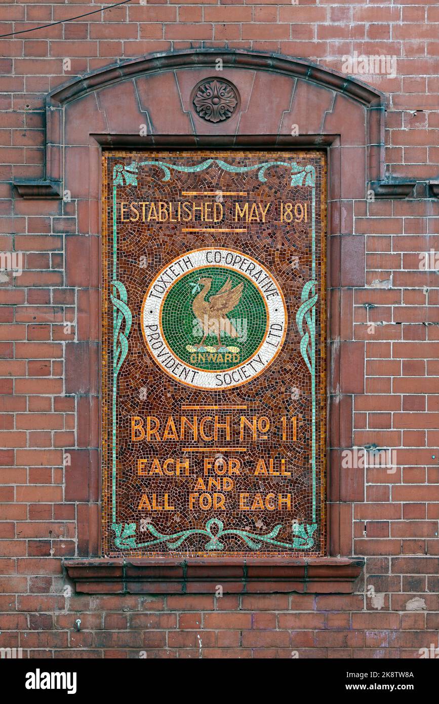 Old mosaic advert for a branch of the Toxteth Co-operative Provident Society, Liverpool, with the slogan, 'Each for all and all for each'. Stock Photo