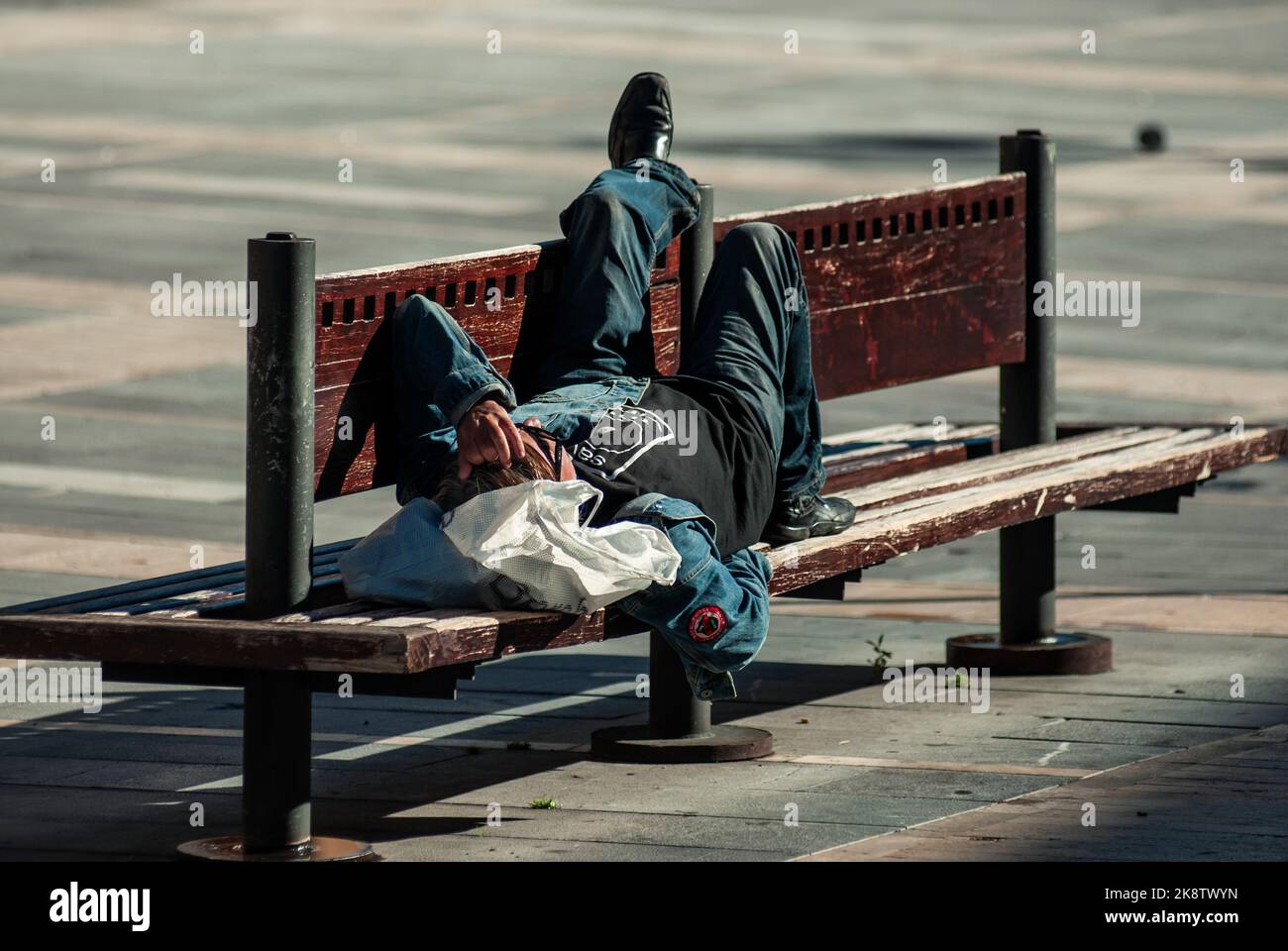 Pilgrim resting on a bench in Leon doing the Camino de Santiago Stock Photo