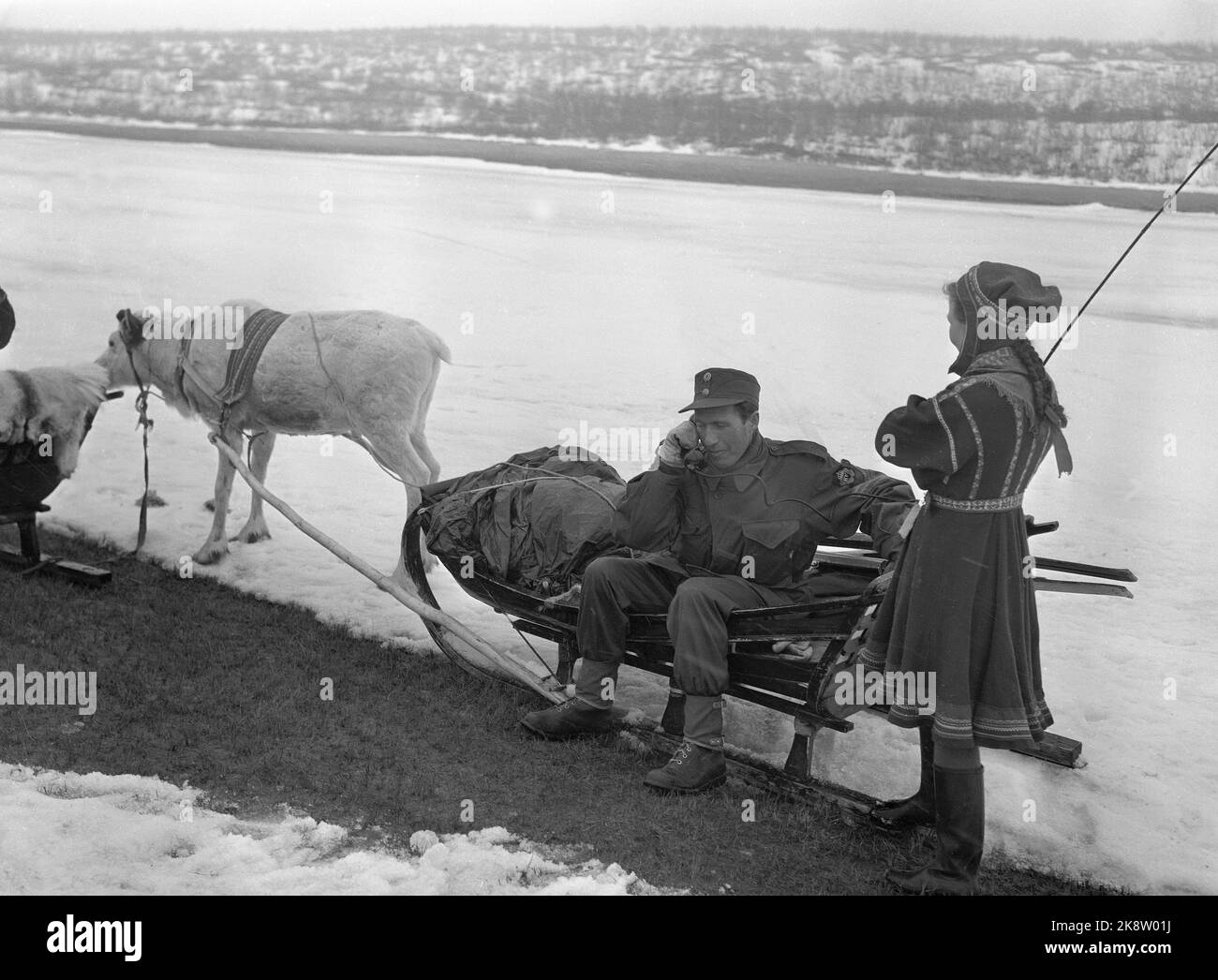 Kautokeino 19600419 The Home Guard has winter exercise in the Kautokeino tracts, and Sami home defense soldiers participate, including with reindeer for transport. Here is a Sami woman with reindeer and sleds, and a home protection soldier talking in the field phone. Photo: NTB / NTB Stock Photo