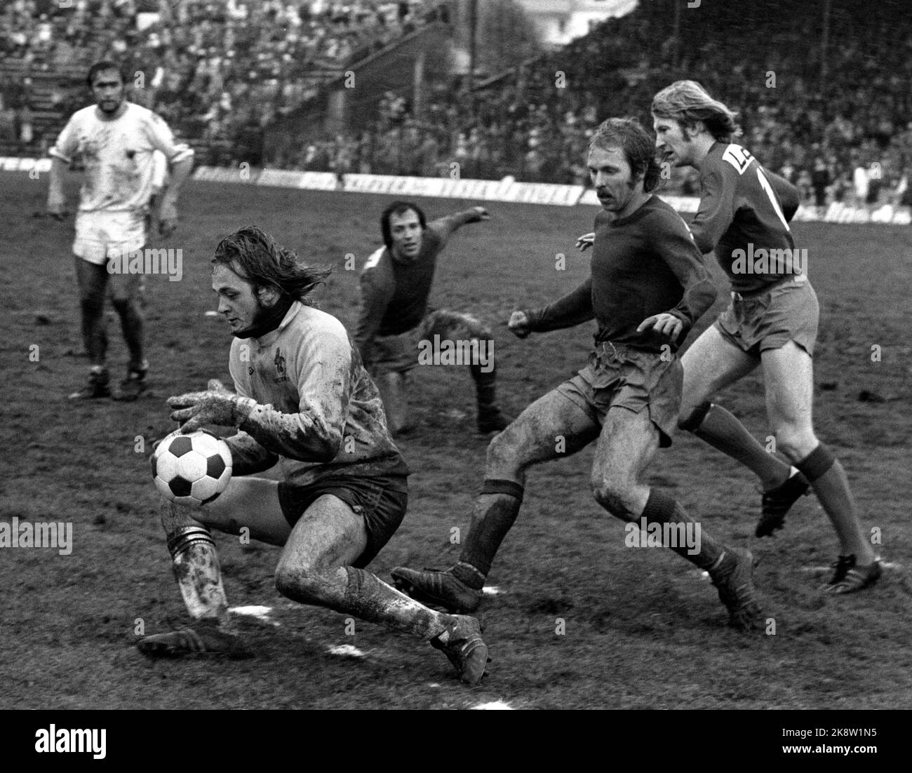Oslo 19741020. Soccer. Cup final Skeid - Viking 3-1, Ullevaal Stadium. Skeid became Norwegian champions in the rain and sleet. In the picture, Bjørn Skjønsberg, Skeid, attacks, but Vikings keeper Erik Johannessen saves. The other Skeid players are Bent Hinze and Frank Olafsen (farthest away). Photo NTB / NTB Stock Photo