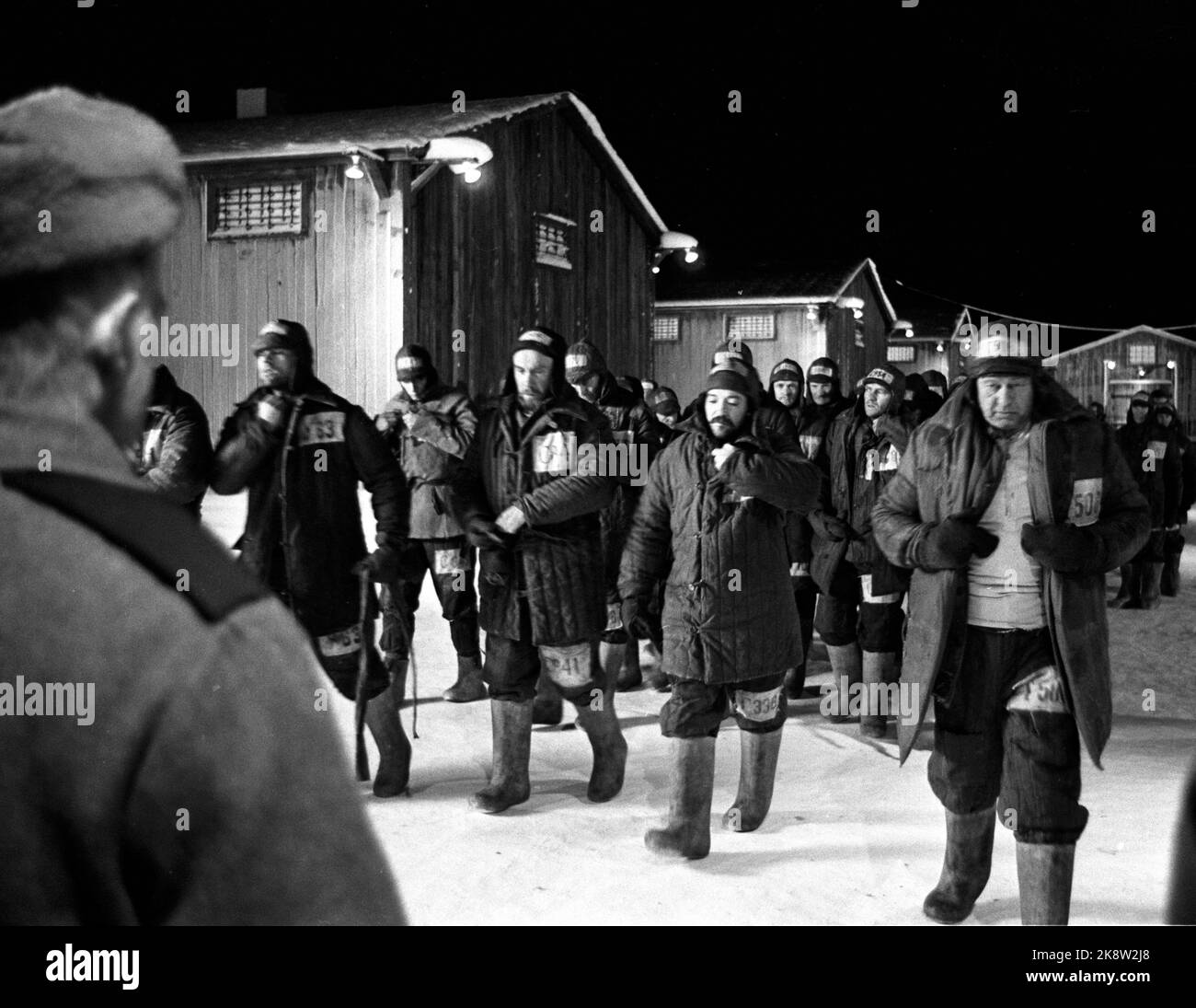 Oslo 19700110 Recording of the movie 'One day in Ivan Denisovich Life' takes place at Røros. Here is a scene from the movie, the prisoners on the march against the guards for checking. From v. The British John Cording (Pavio), Espen Skjønberg (Tiurin), Eric Thompson (Tsesar) and Frimann Falck Clausen (Senka). The camp management had a msitic that the prisoners were wearing more clothes than the regulations allowed, and therefore they were investigated. Photo: Photo: Sverre A. Børretzen / Current / NTB Stock Photo