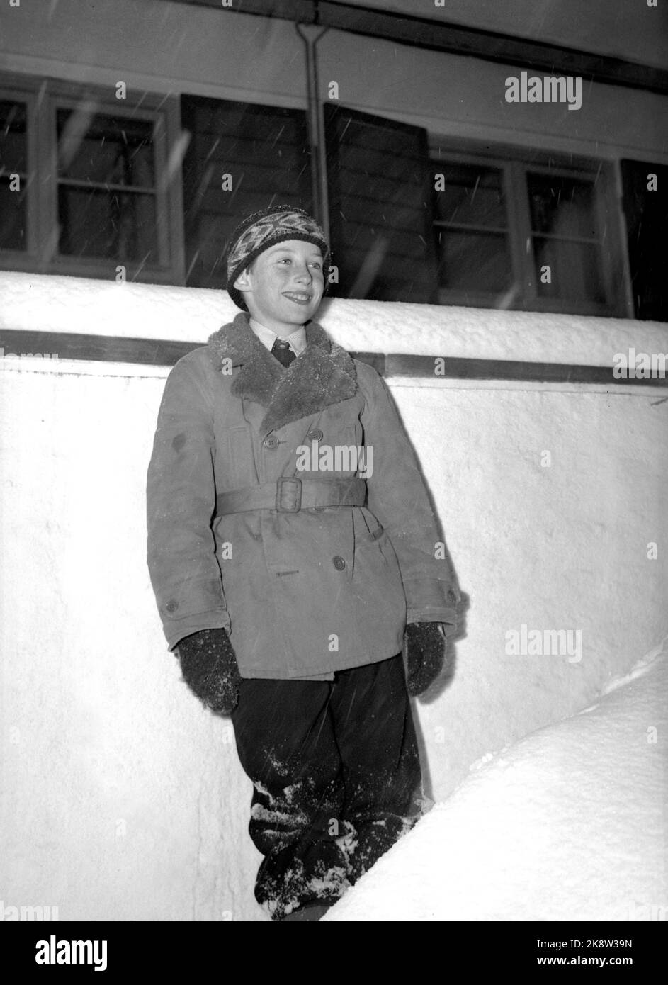 Asker 19460219. Prince Harald photographed at Skaugum in connection with the 9th anniversary. Here we see him in snow outside the house. Smiling. Ntb archive / ntb Stock Photo