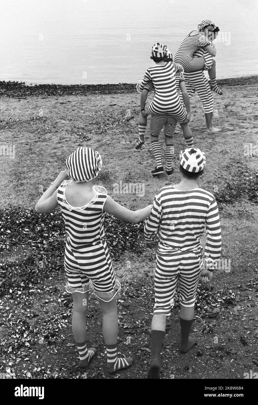 Oslo 19690510: Frogner Park. Young women and men wearing striped retro-style bathing suits. This swimsuit fashion is from around the 1920s, but flared up again in the summer of 1969. Excerpt from text in the current: 'Older people stood with tears in their eyes as we presented the swimsuits. The sale of the new, old swimsuit has gone striking, especially among this year's Russian charcoal , which has bet on the stripes. The suits can be purchased anywhere for a barely five. ' Photo: Aage Storløkken / Current / NTB Stock Photo