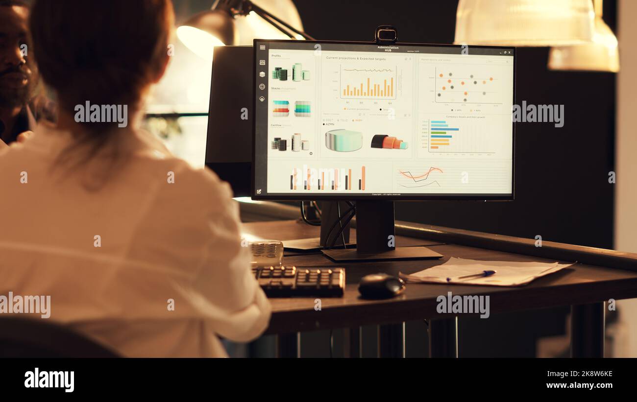 Startup employee analyzing company diagrams on computer, planning ...