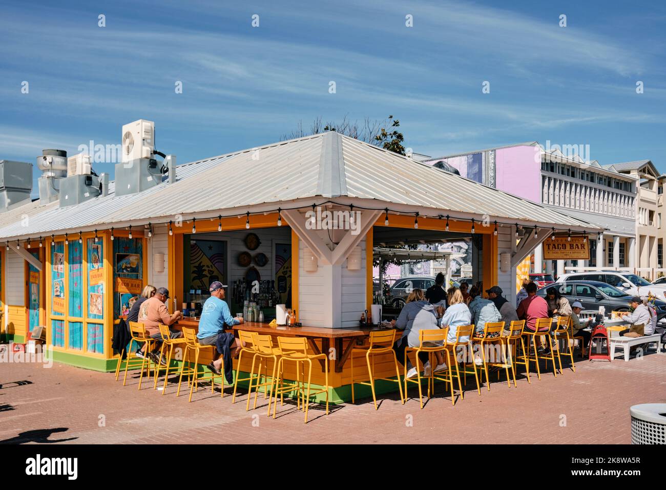 People ordering and eating at a an outdoor taco bar or taco stand restaurant in the resort town of Seaside Florida, USA. Stock Photo