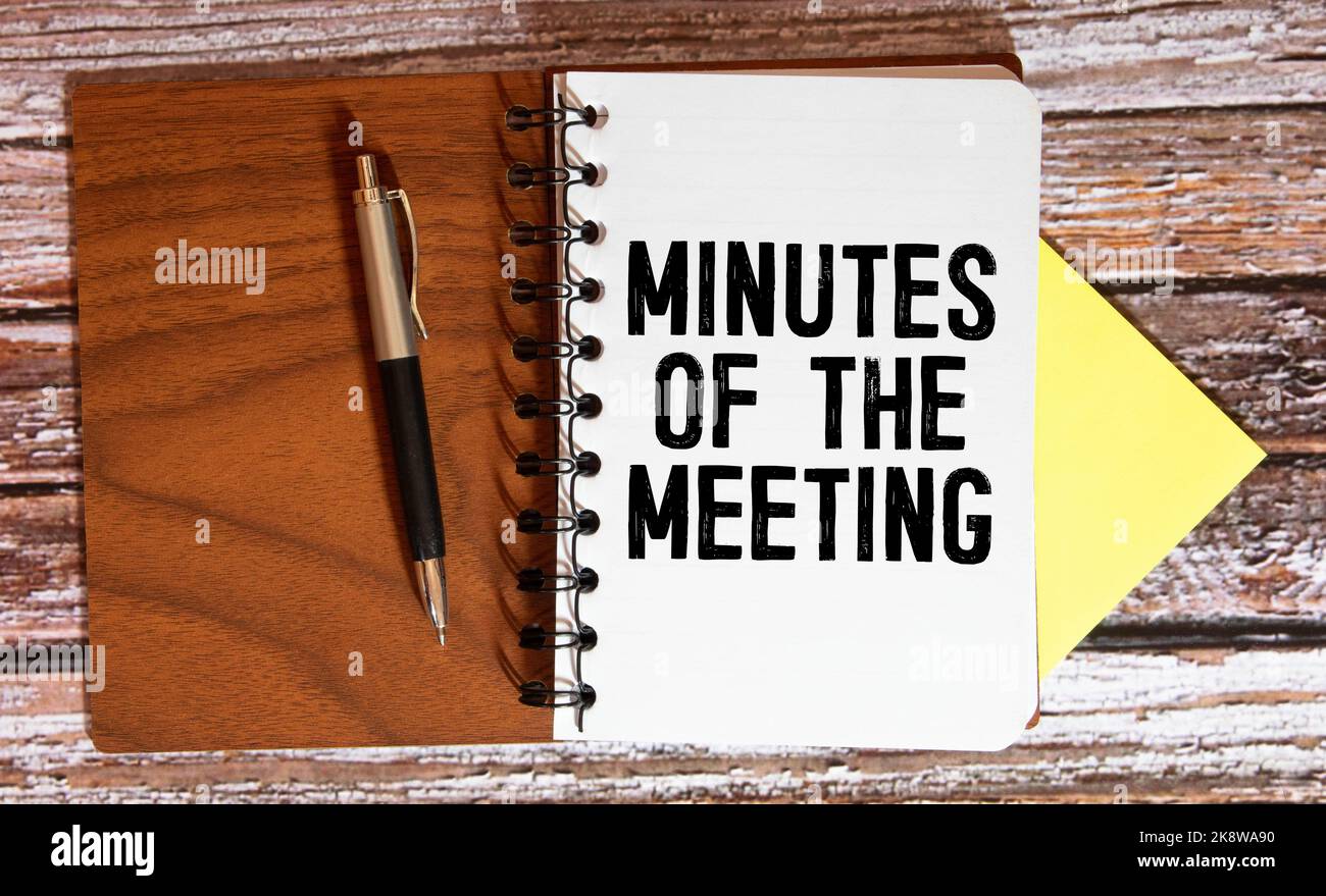 Notebook with Tools and Notes with text MINUTES OF THE MEETING. Stock Photo