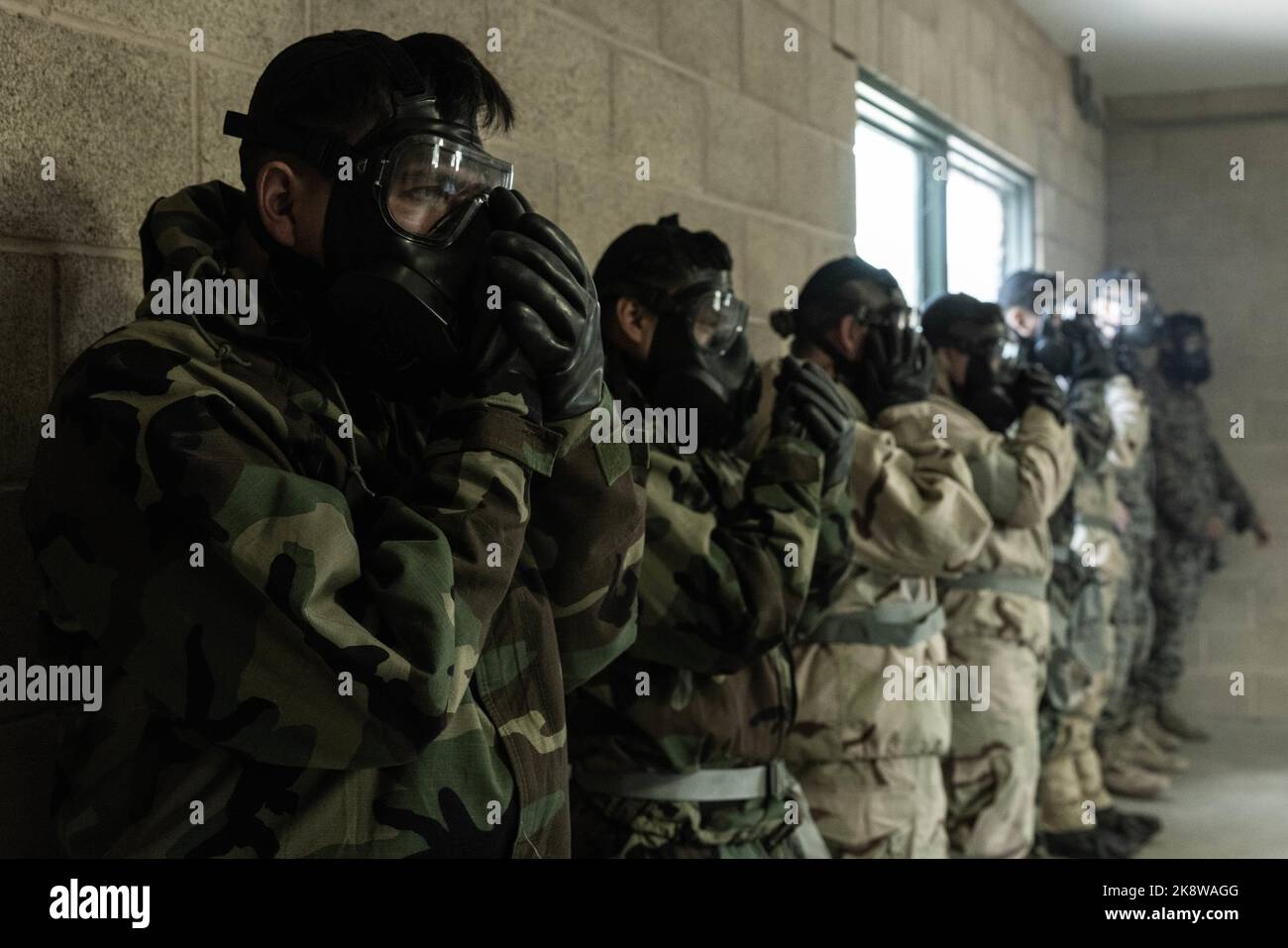 U.S. Marines with Headquarters Battalion, 1st Marine Division, clear their masks of chlorobenzalmalononitrile gas, commonly known as CS gas, during chemical, biological, radiological and nuclear defense training at Marine Corps Base Camp Pendleton, California, Oct. 20, 2022. CBRN training is conducted annually to ensure Marines know how to use their protective gear in the event of a chemical attack. (U.S. Marine Corps photo by Lance Cpl. Kayla Halloran) Stock Photo