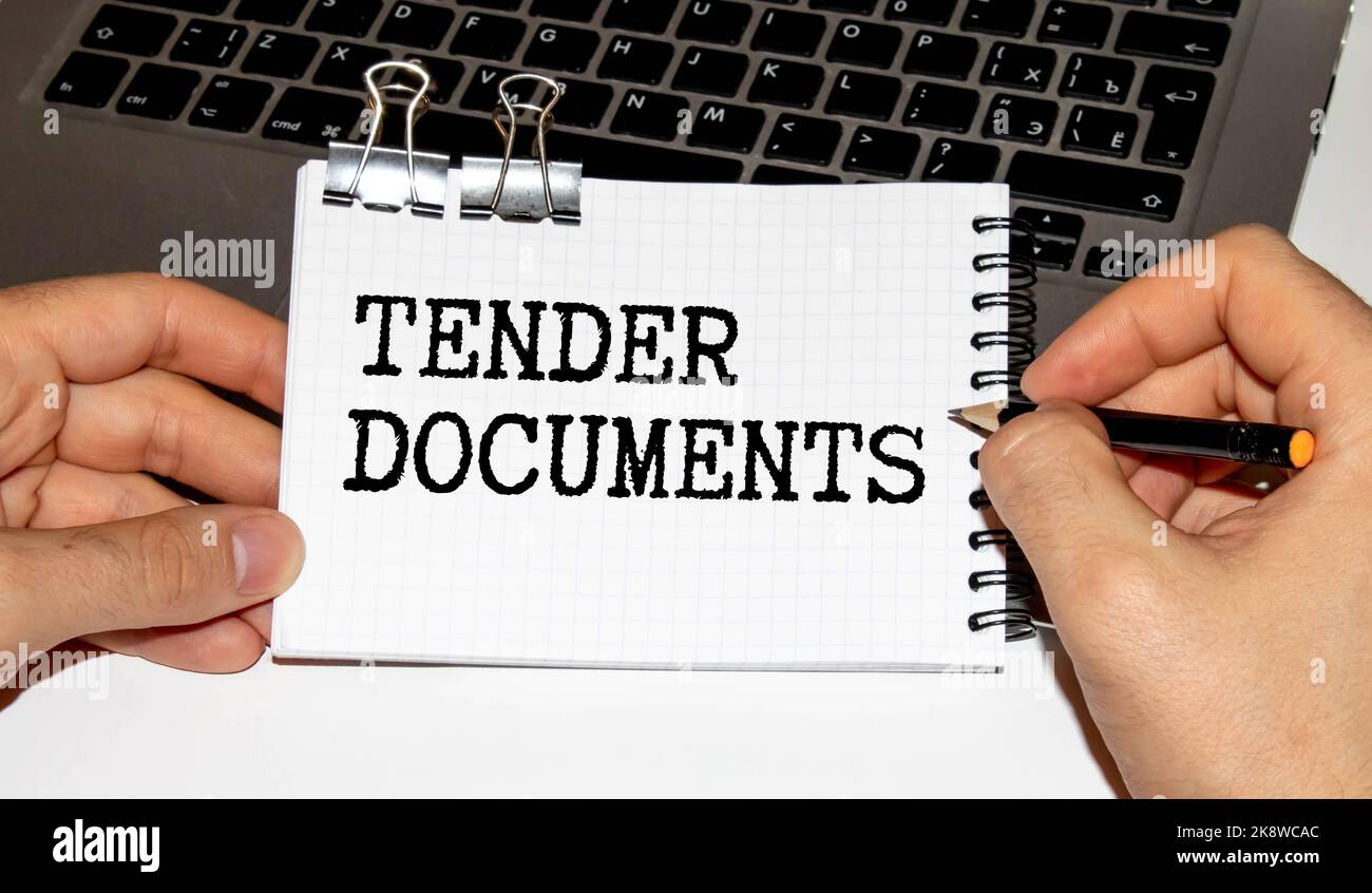 Tender written text on paper note in businessman hand. Business 