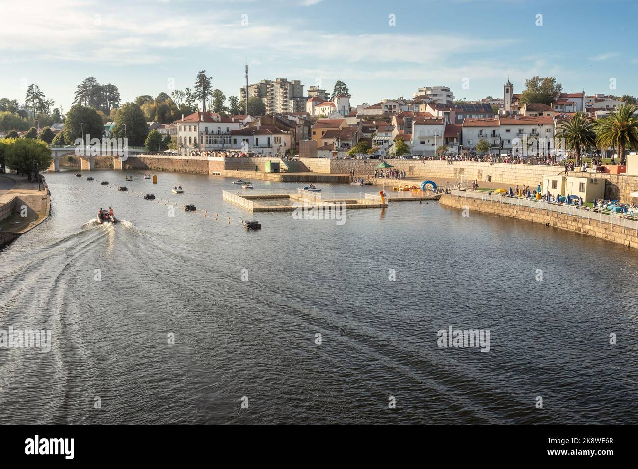 City of Águeda in Portugal, view over the river Águeda with the houses in the background, on a summer afternoon. Stock Photo