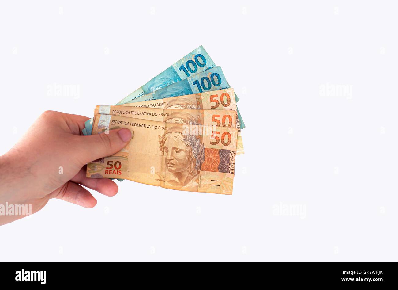 Hand holding Brazil's official money. Brazilian Real banknotes Stock ...