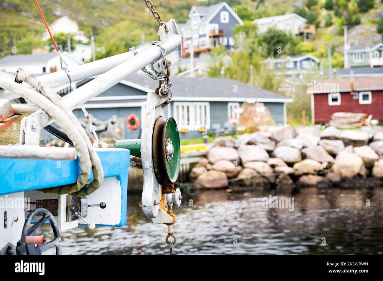 A pulley used for winching lobster traps and crab traps on a fishing boat while docked at a pier in Petty Harbour Newfoundland Canada. Stock Photo