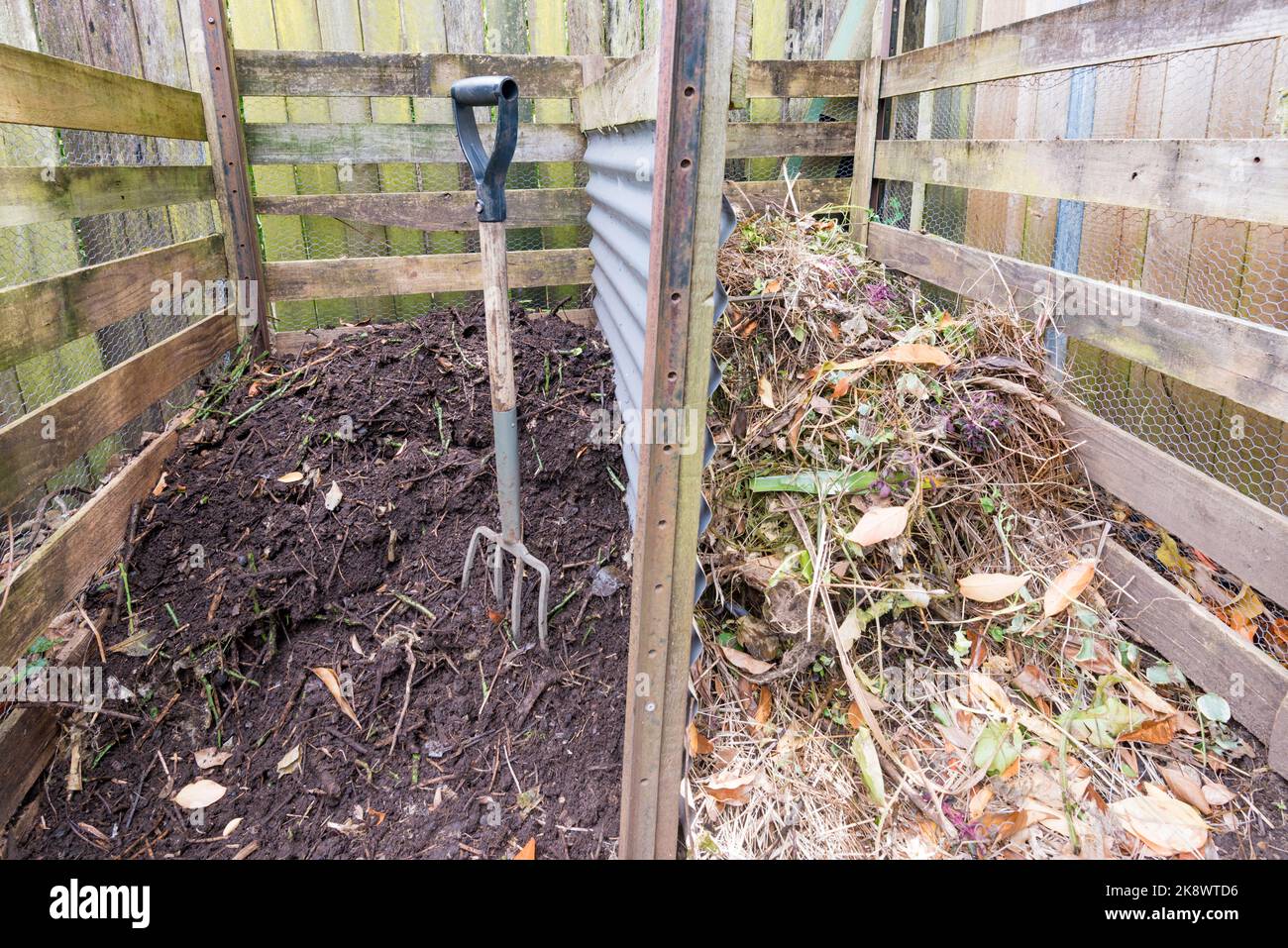 An Australian two bay, homemade compost heap with turned fresh-cut vegetation in one and compost humus nearly ready for use in the other Stock Photo