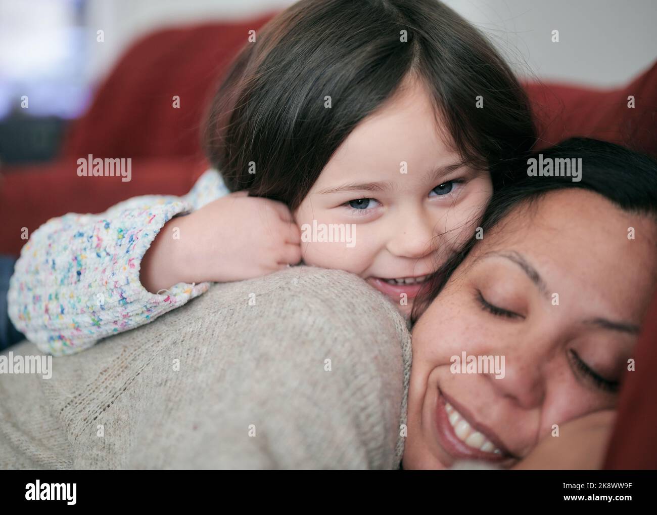 Young girl hugging mom with affection Stock Photo