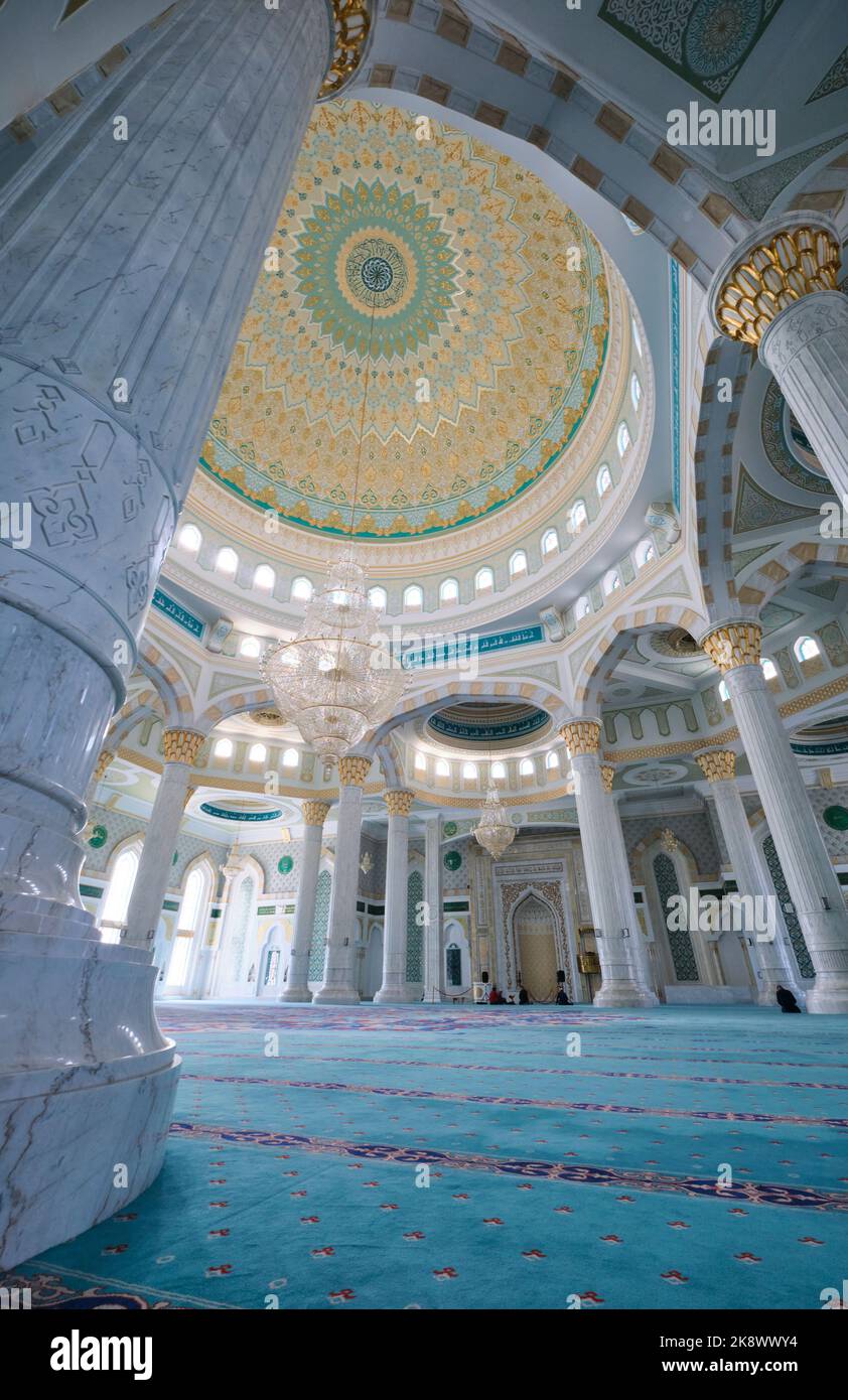 Column Mosque Blue Interior of the richly appointed mosque, with blue-green carpet ...