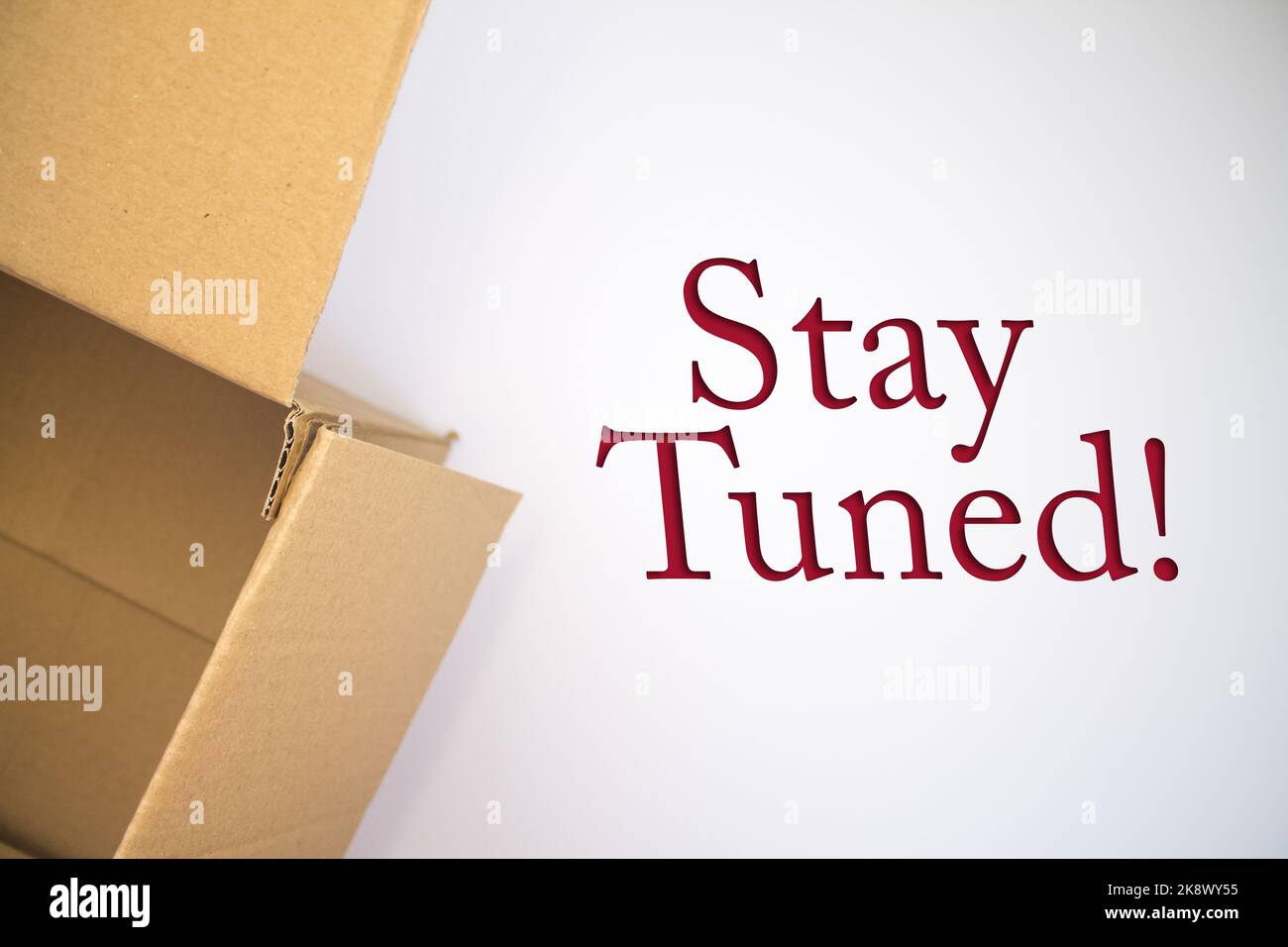 Staying Boxed In Stay Tuned word with cardboard box. Brown folded card box Stock Photo ...