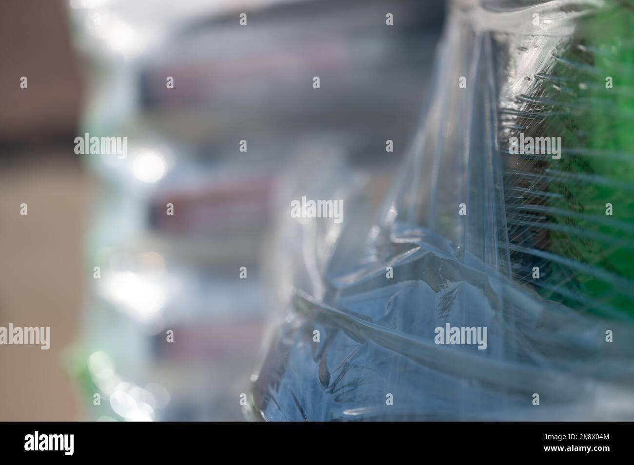 Selective focus on cellophane shrink wrap on pallets of goods for