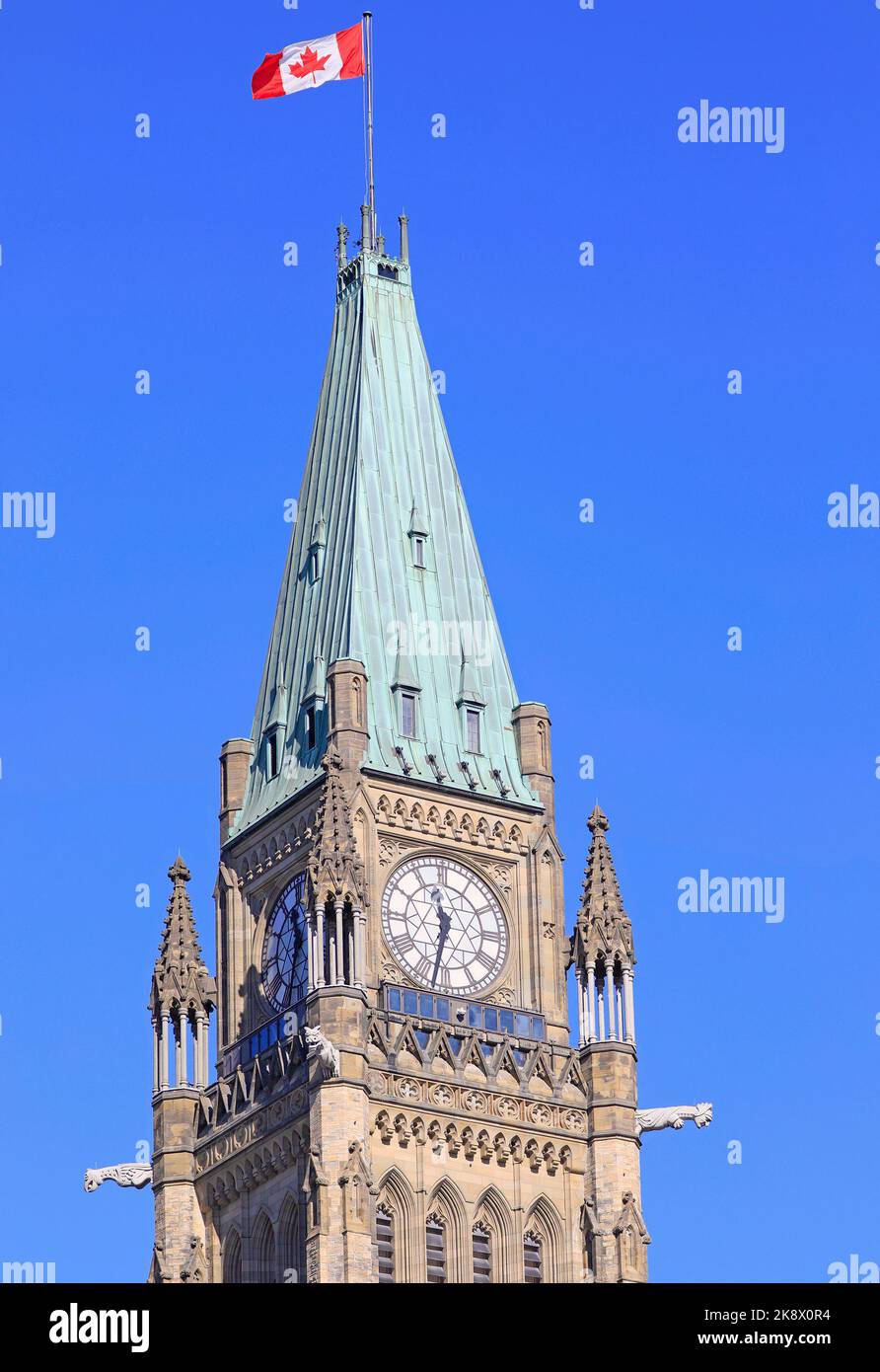 Peace Tower detail with Canadian Flag waving, Canada Stock Photo