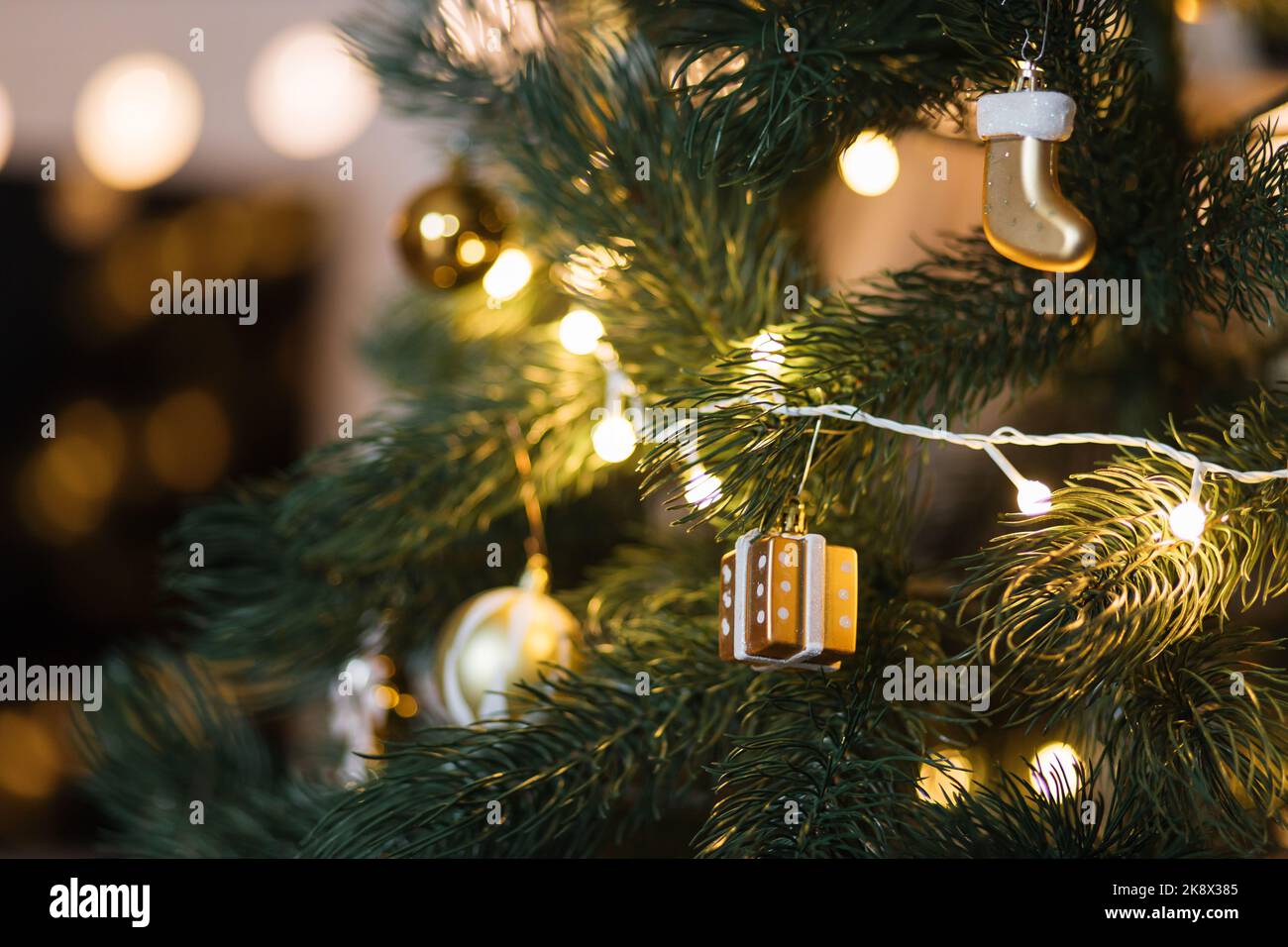Golden Christmas tree toys on green branches of a Christmas tree ...