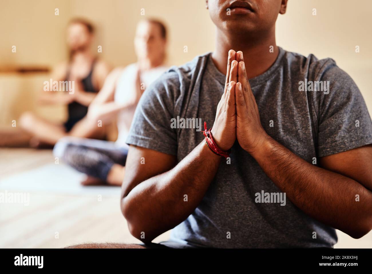 Tomorrow depends on what you do today. a group of young men and women meditating in a yoga class. Stock Photo