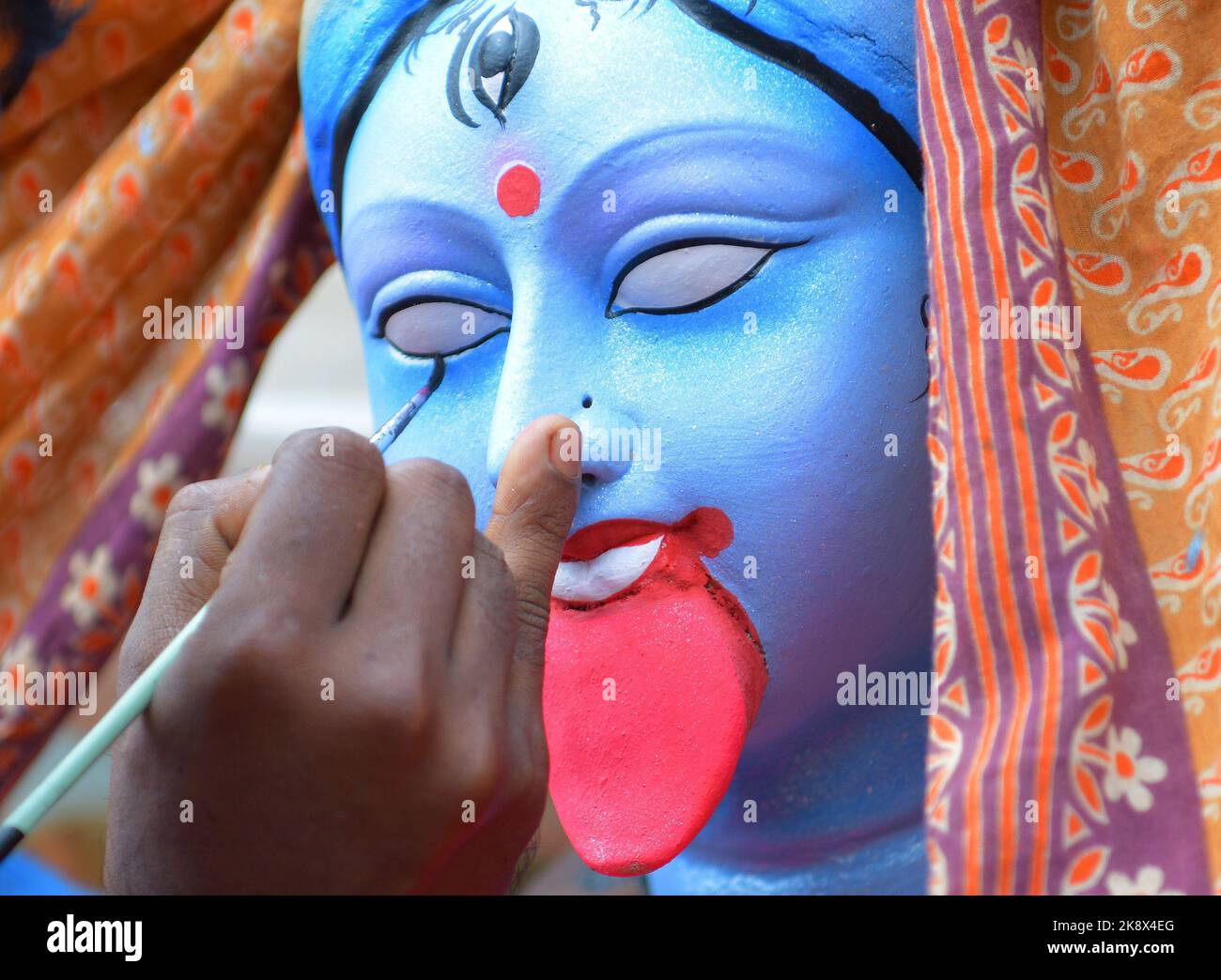 Kali Rama An artisan doing the finishing touches to a semi-finished clay idol of ...