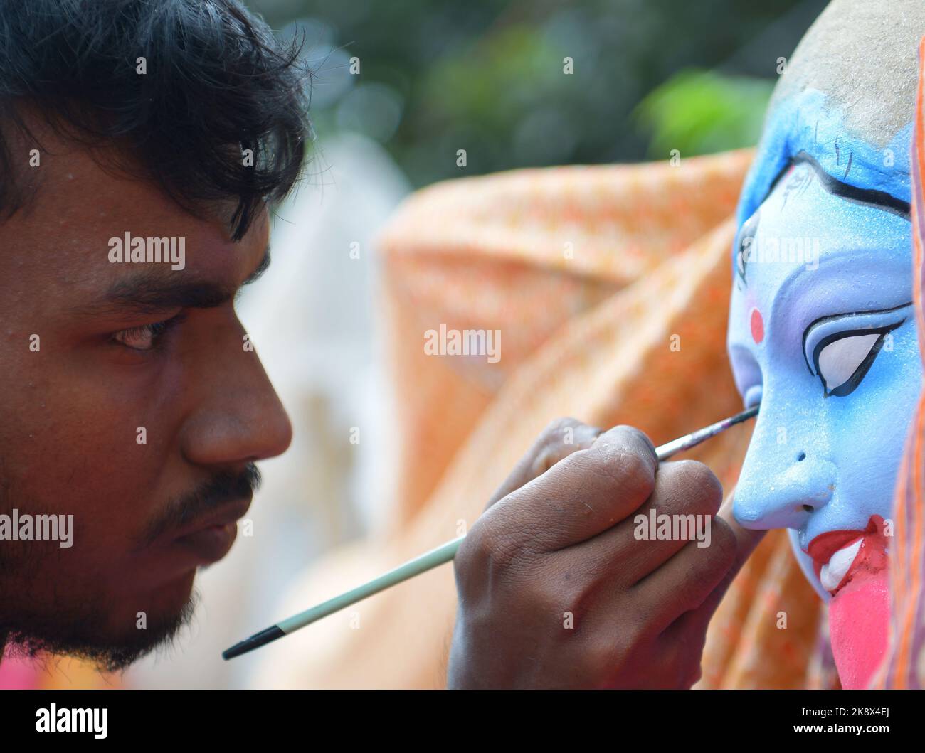 Kali Rama An artisan doing the finishing touches to a semi-finished clay idol of ...