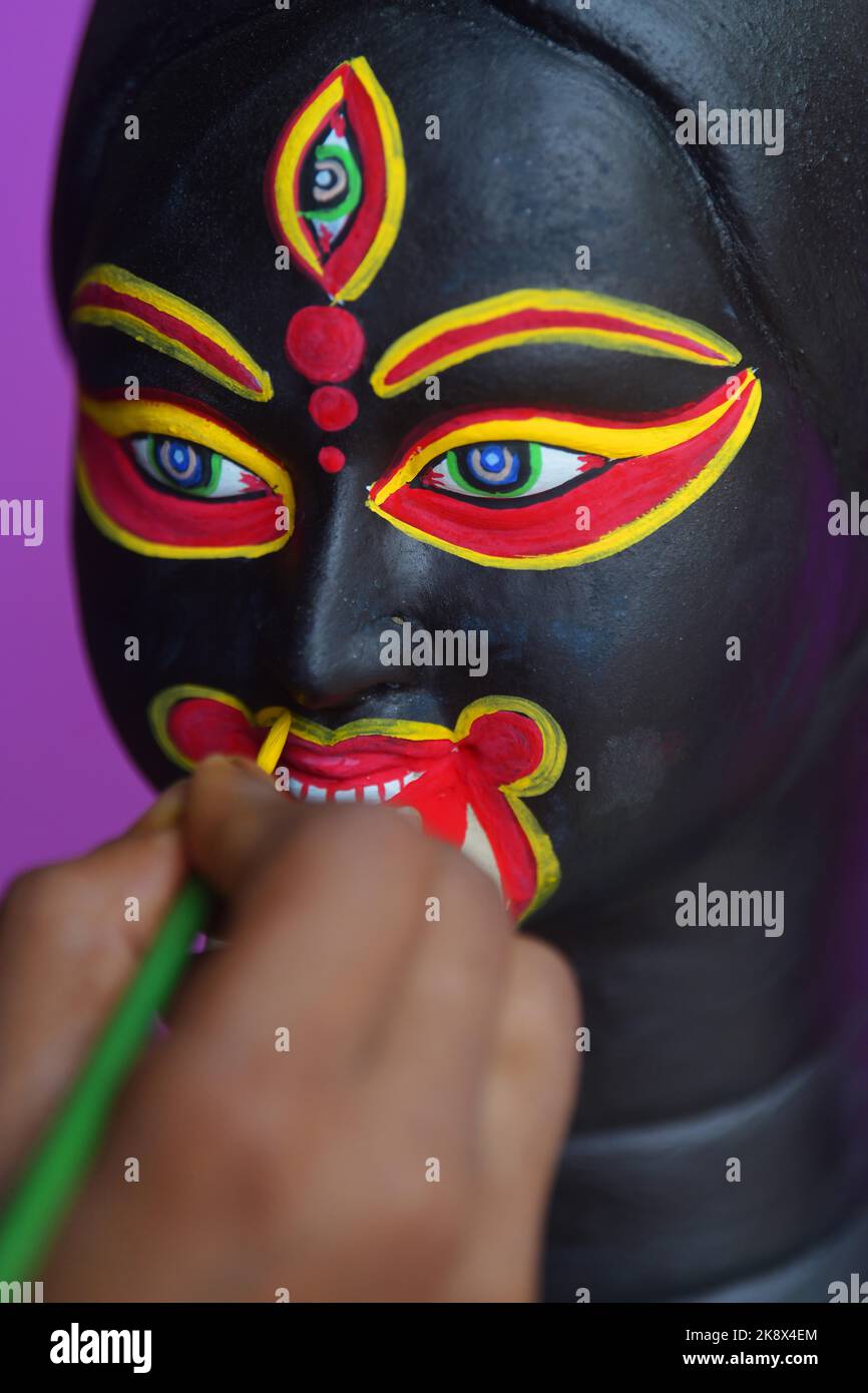 Kali Rama An artisan doing the finishing touches to a semi-finished clay idol of ...