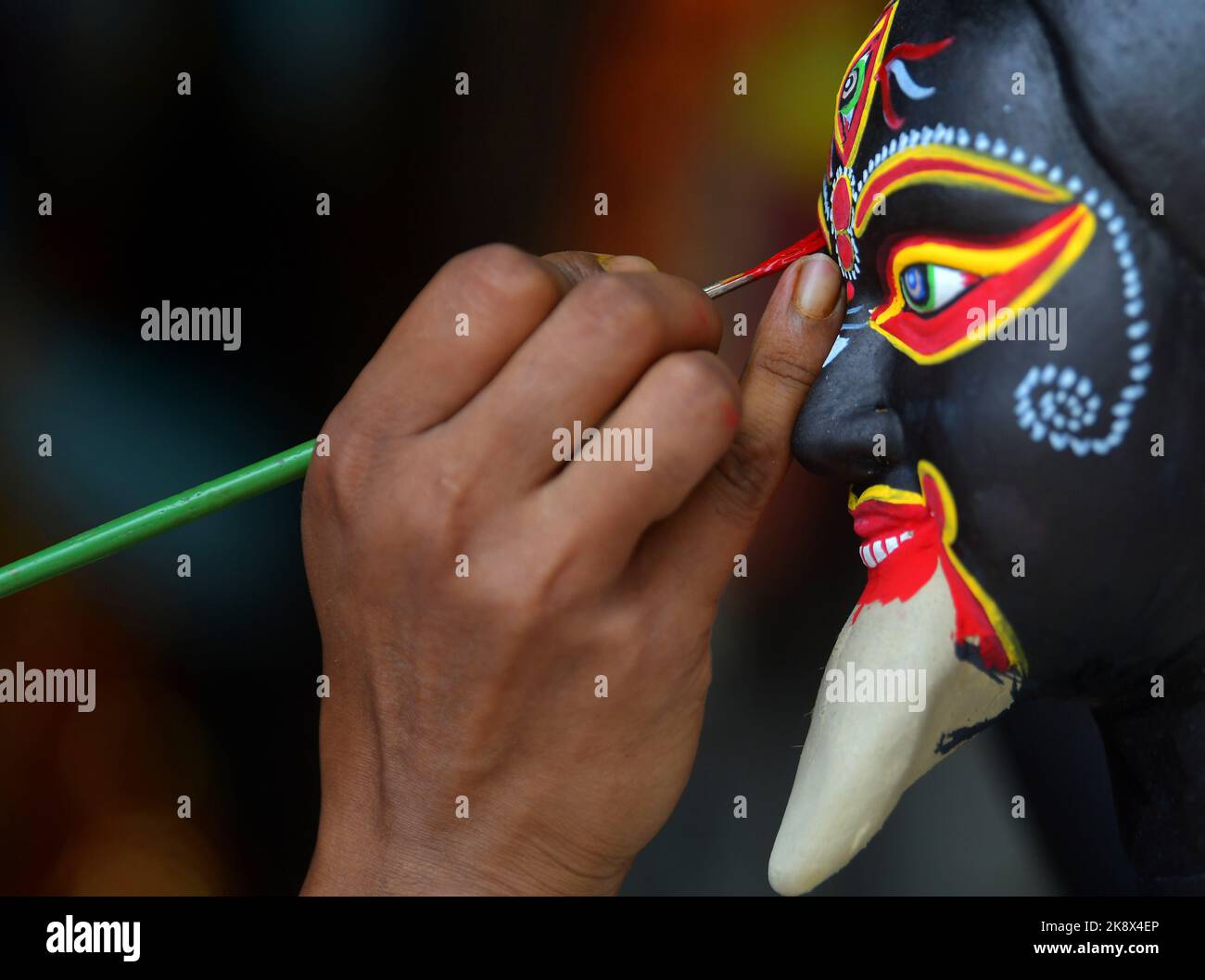 Kali Rama An artisan doing the finishing touches to a semi-finished clay idol of ...