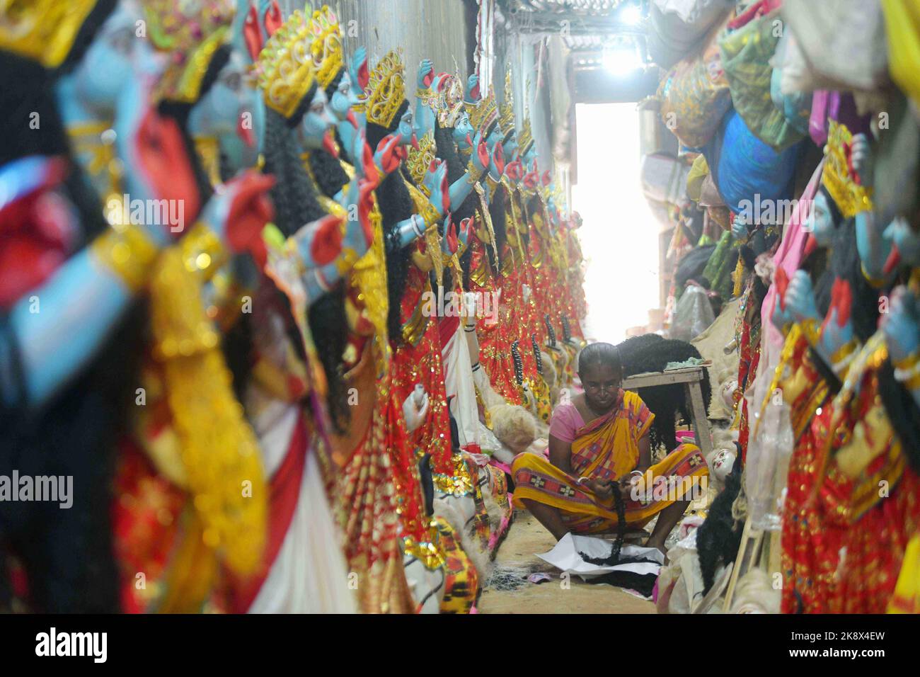 Kali Rama An artisan doing the finishing touches to a semi-finished clay idol of ...