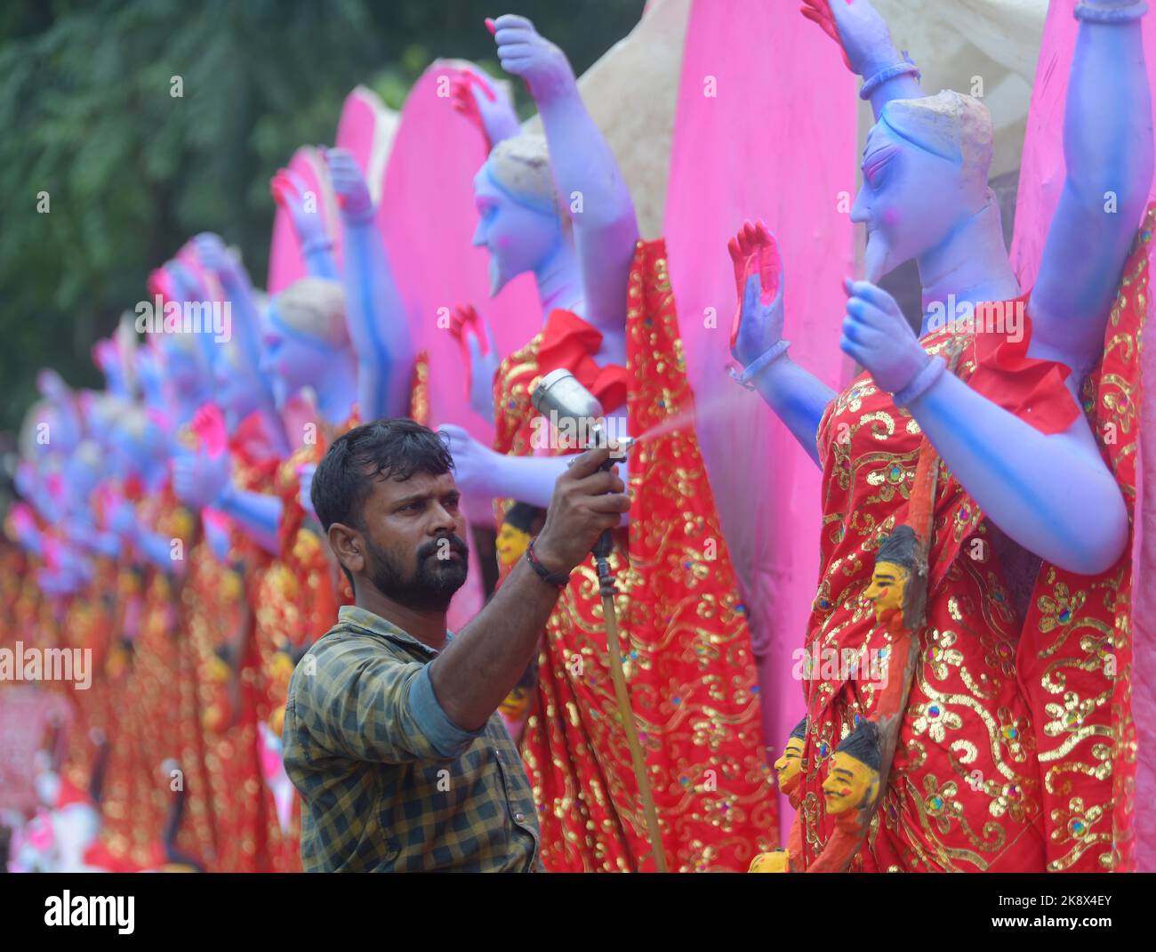 Kali Rama An artisan doing the finishing touches to a semi-finished clay idol of ...