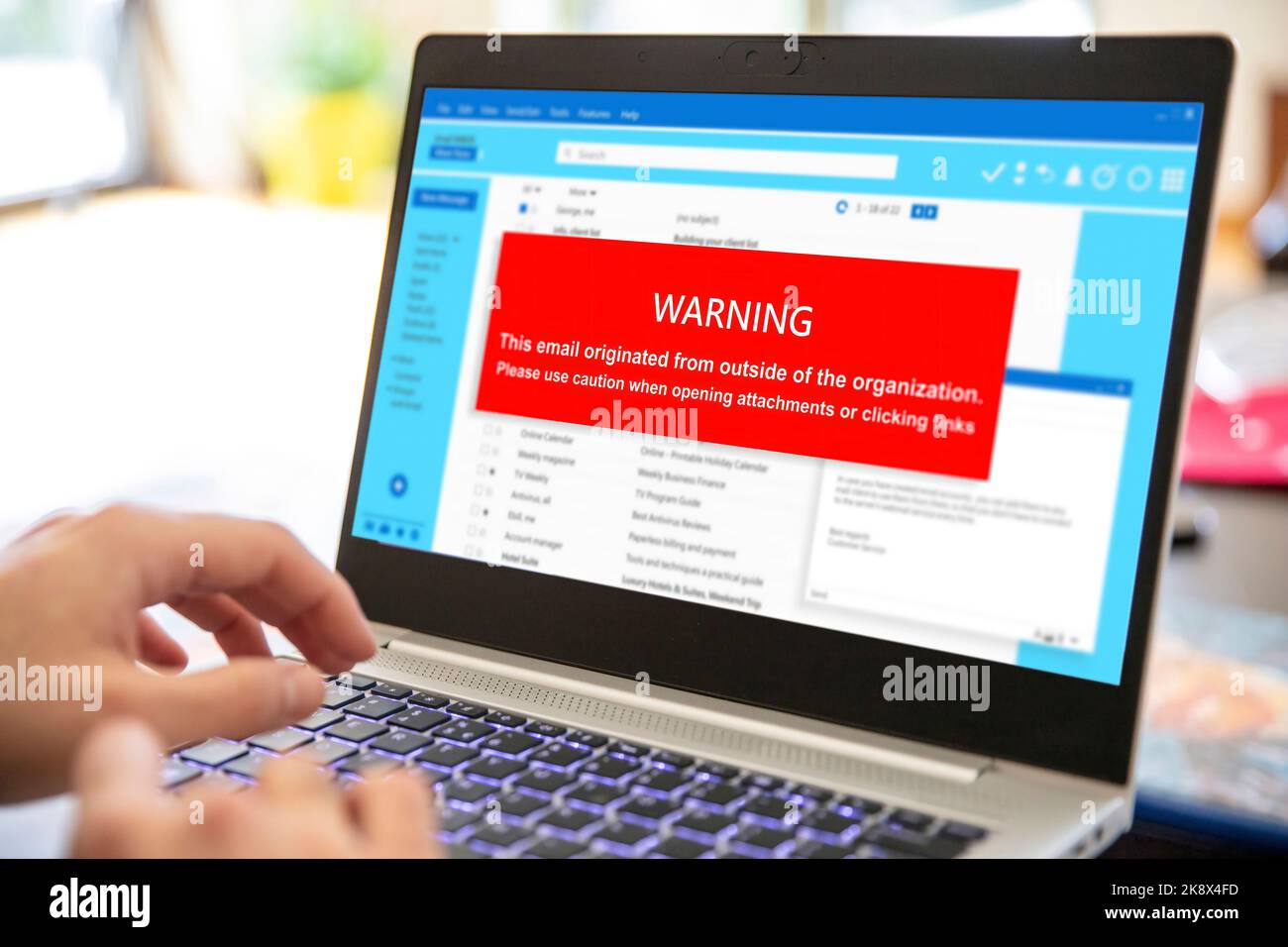 Email attachments warning message on a laptop screen. Computer Virus and Antivirus. Cyber security concept. Stock Photo